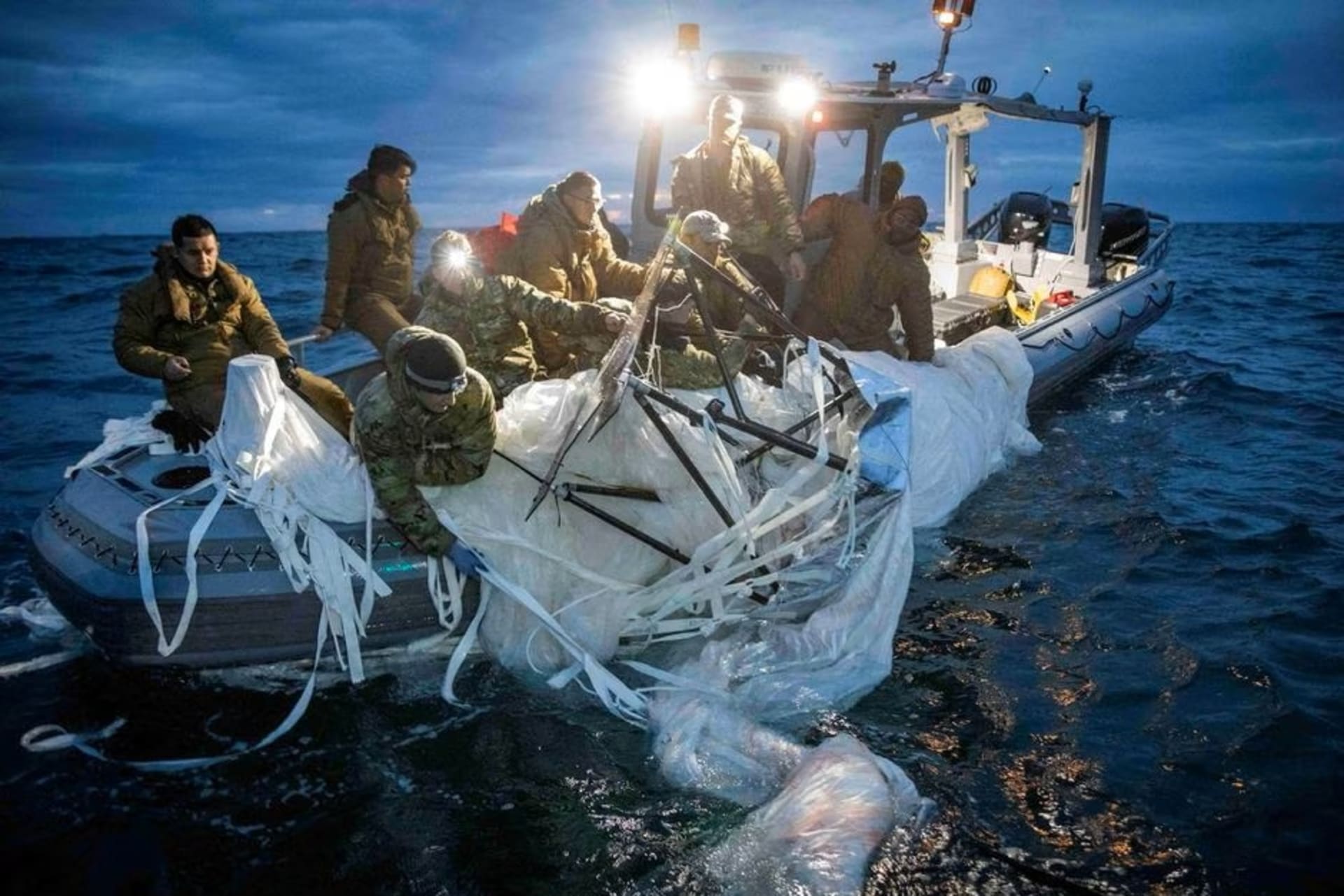 <p>Soldiers pull a portion of a Chinese spy balloon shot down over the ocean into a small dinghy off the coast of South Carolina.</p>
