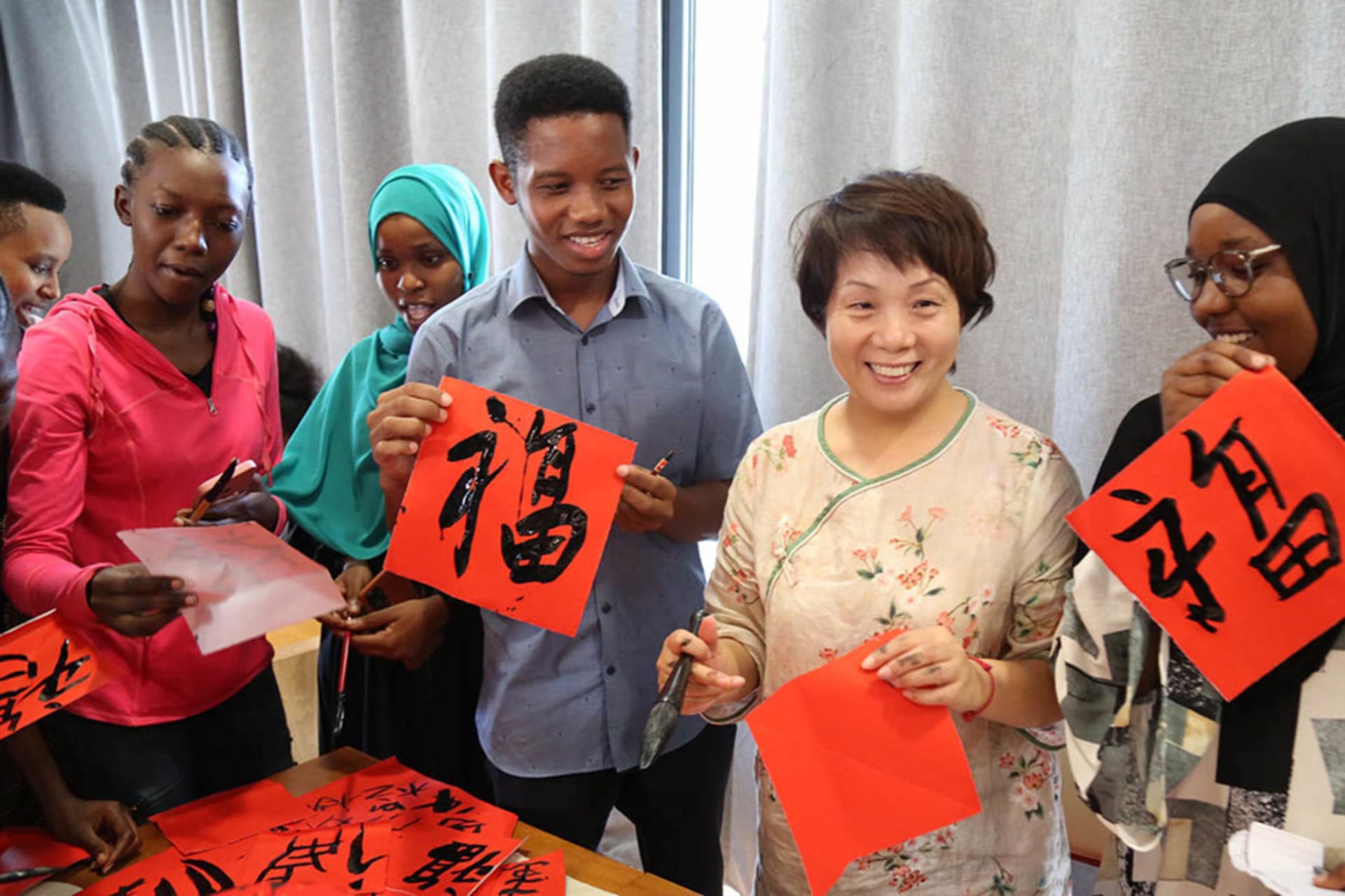 <p>Students display their calligraphy works during an event greeting the Chinese Lunar New Year at the Confucius Institute of University of Dar es Salaam in Tanzania on January 11, 2023.</p>
