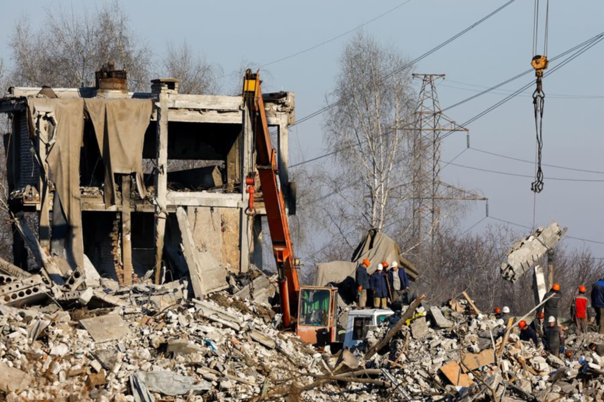 <p>Workers remove debris in the aftermath of a Ukrainian strike on January 1st on a vocational school housing Russian soldiers, which reportedly killed hundreds of Russian soldiers.</p>
