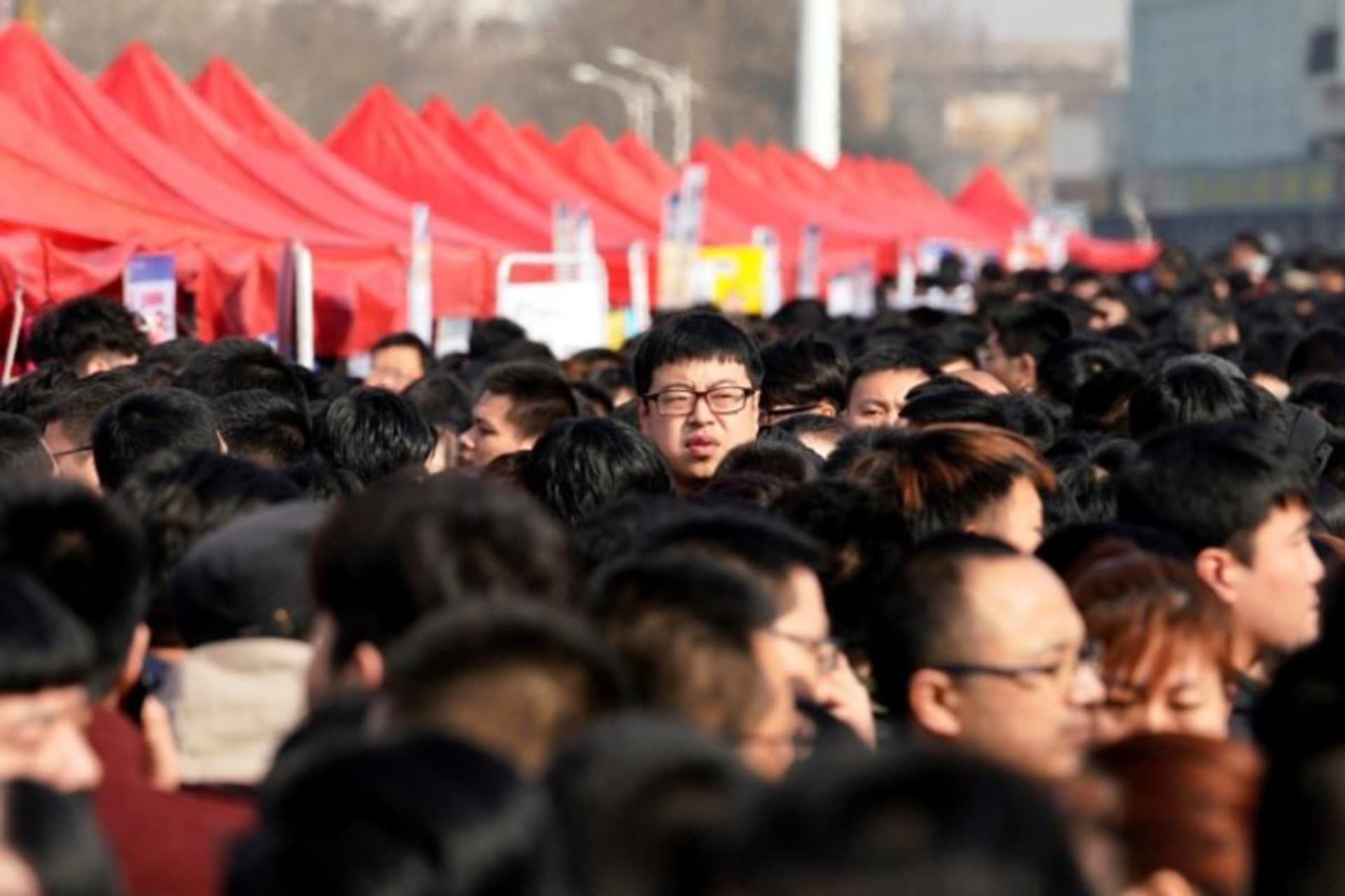 <p>A man looks over a crowd in Shijiazhuang, Hebei province, China.</p>
