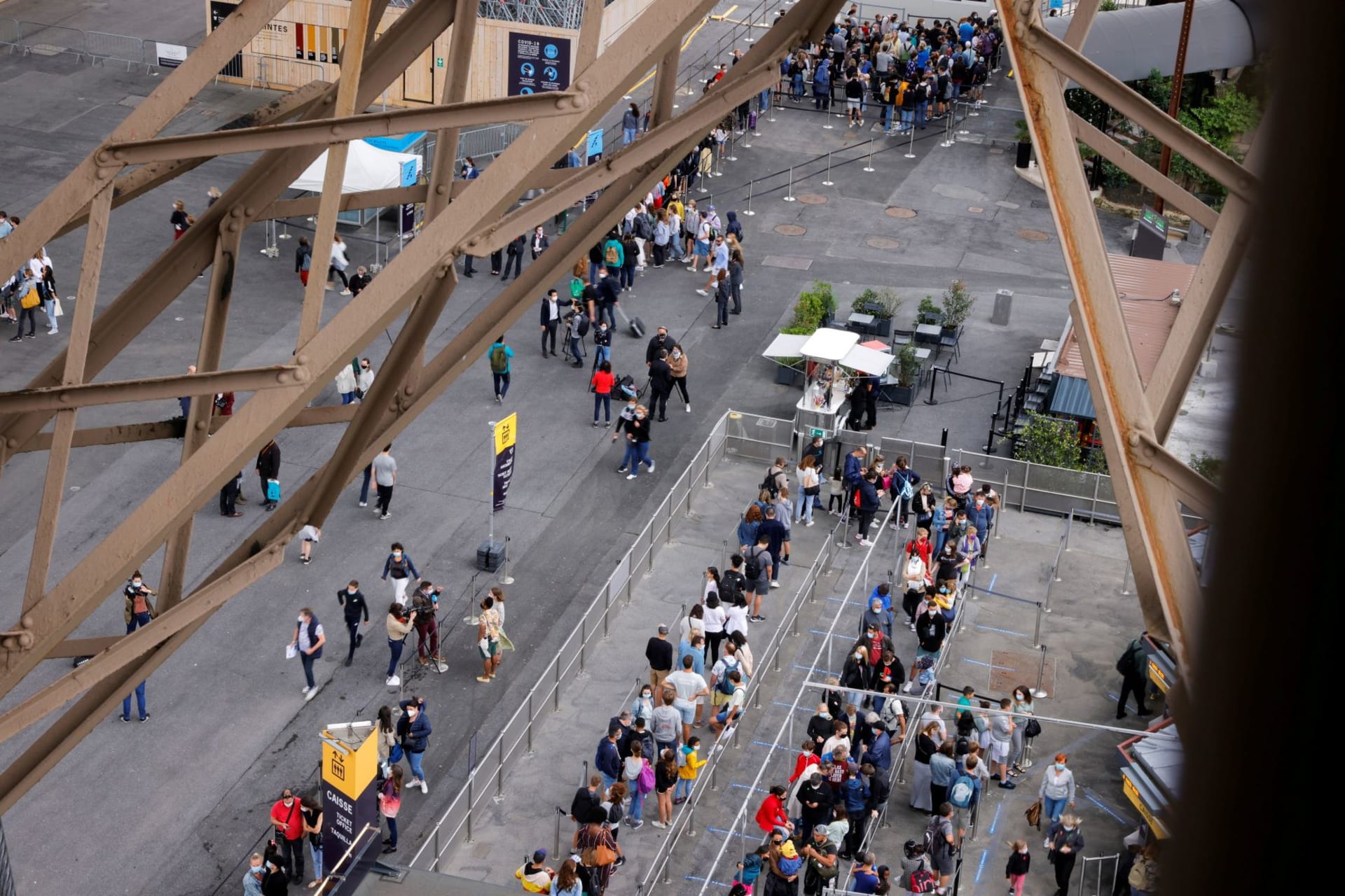 <p>Sightseers wait in line for the Eiffel Tower after it reopened to tourists following a national lockdown. </p>
