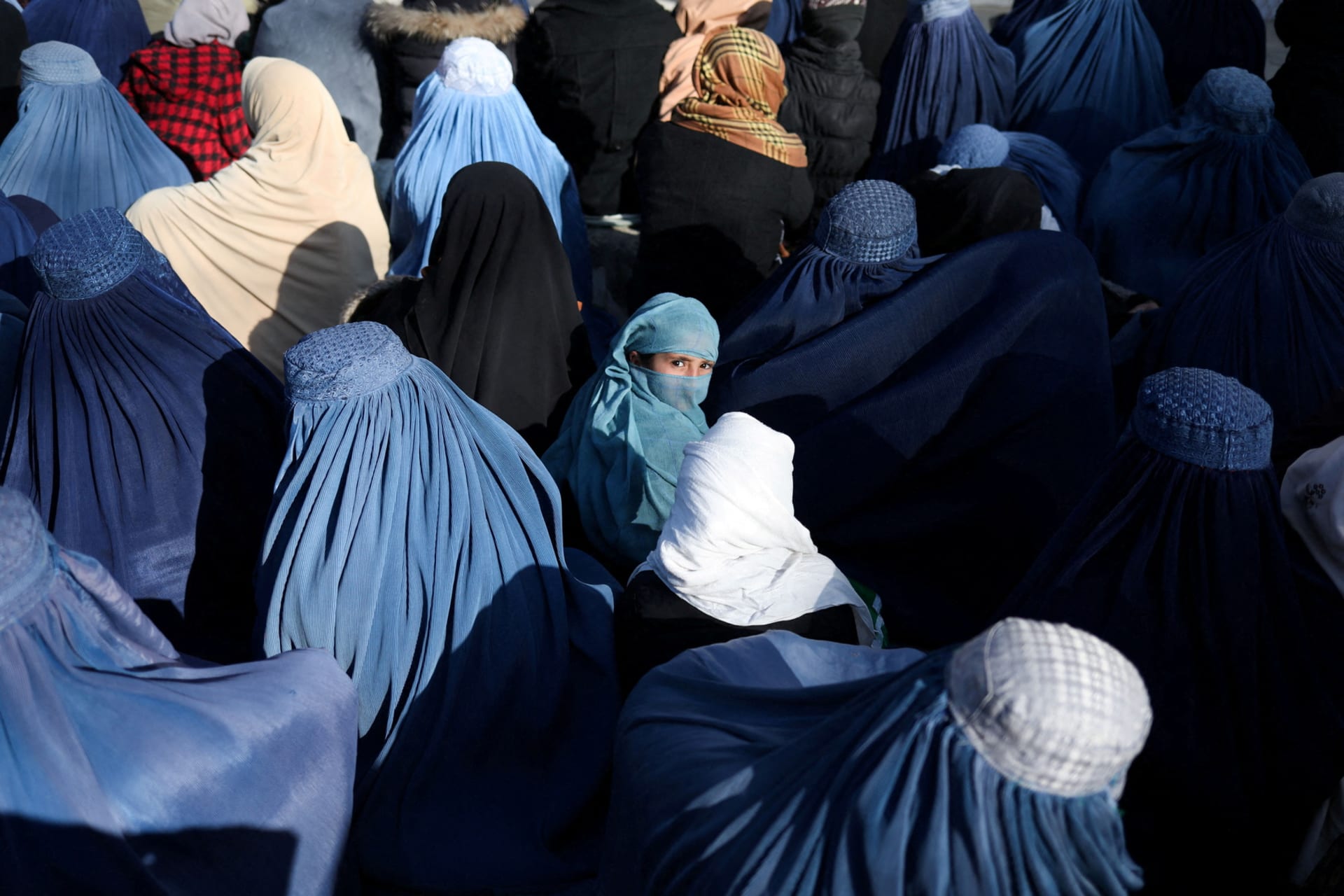 <p>People wait to receive bread in Kabul.</p>
