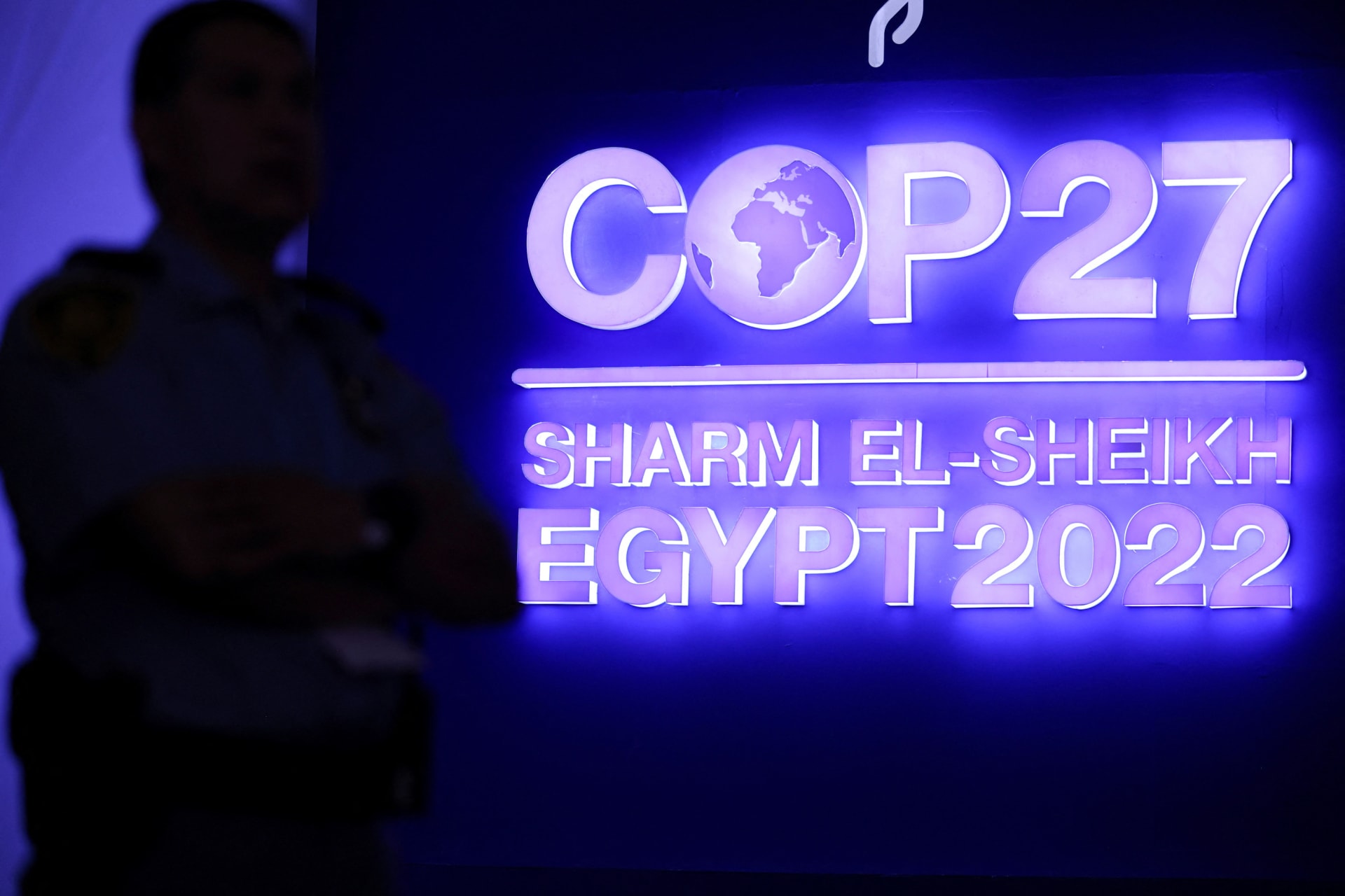 <p>A security guard stands in front of the sign for the COP 27 climate summit in Sharm el-Sheikh, Egypt</p>
