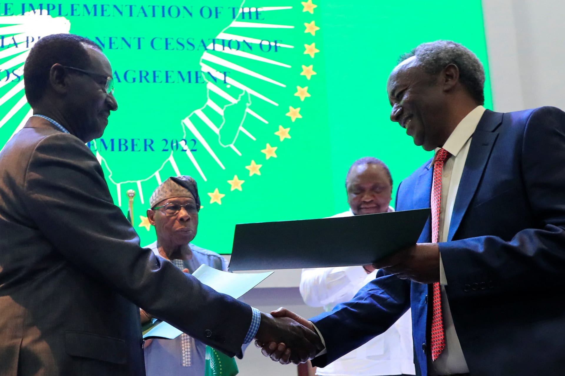 <p>Field Marshal of the Ethiopian National Defense Force Birhanu Jula shakes hands with Commander-in-Chief of Tigray forces Tadesse Werede Tesfay, after signing the implementation on cessation of hostilities agreement in Nairobi, Kenya on November 12, 2022.</p>
