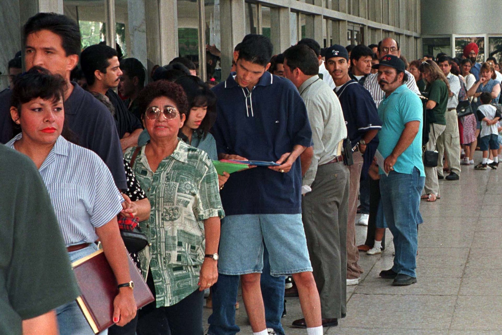 <p>A group of immigrants, who qualify for residency in the United States but do not yet have their legal papers, stand in line at the Immigration and Naturalization Service offices in Los Angeles. </p>
