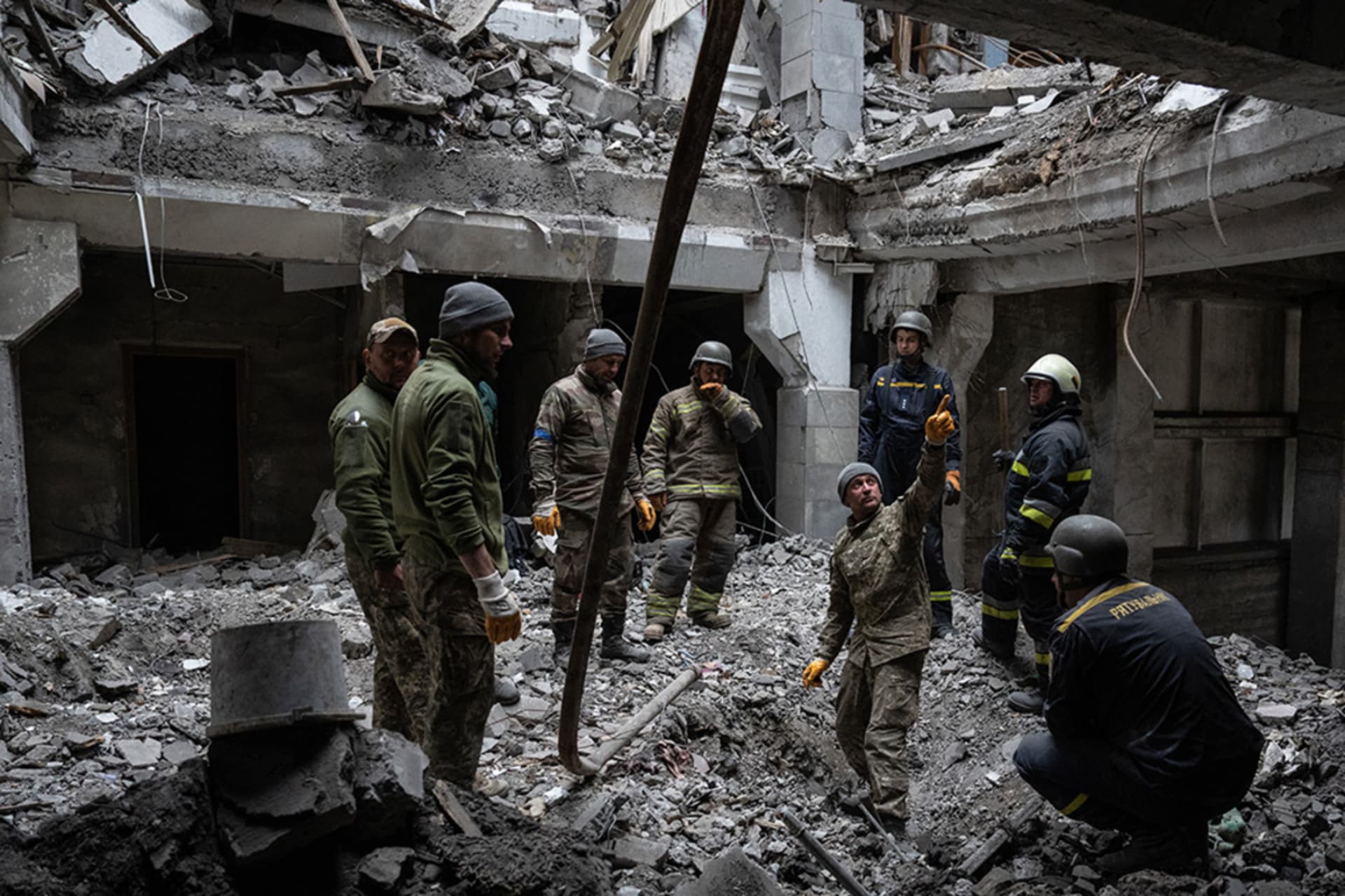 <p>A soldier searches for bodies in a building struck by a Russian missile on October 13, 2022 in Kupiansk, Kharkiv oblast, Ukraine.</p>
