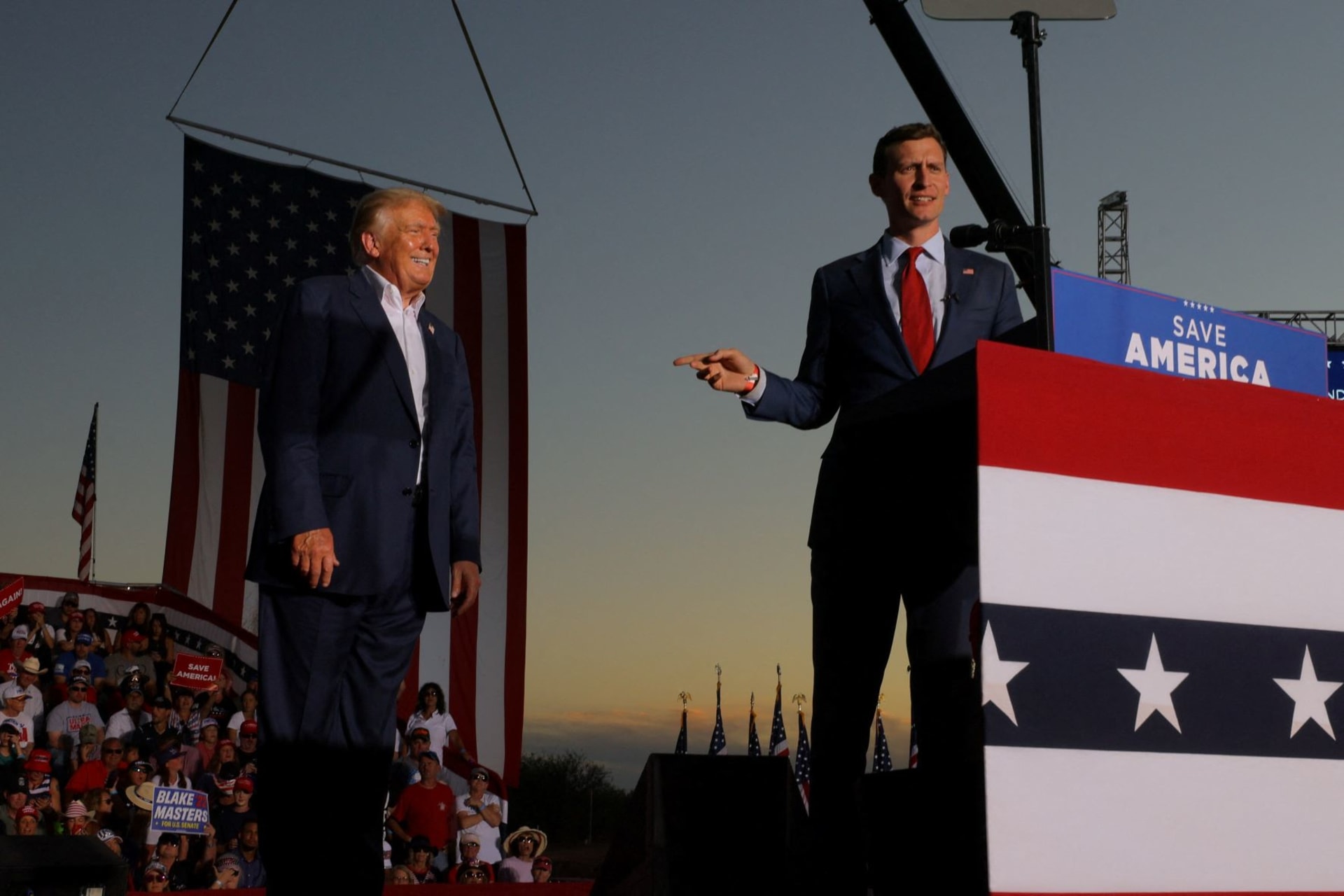<p>U.S. Senate candidate Blake Masters (R-AZ) speaks next to former U.S. President Donald Trump during a rally ahead of the midterm elections, in Mesa, Arizona, U.S., October 9, 2022.</p>