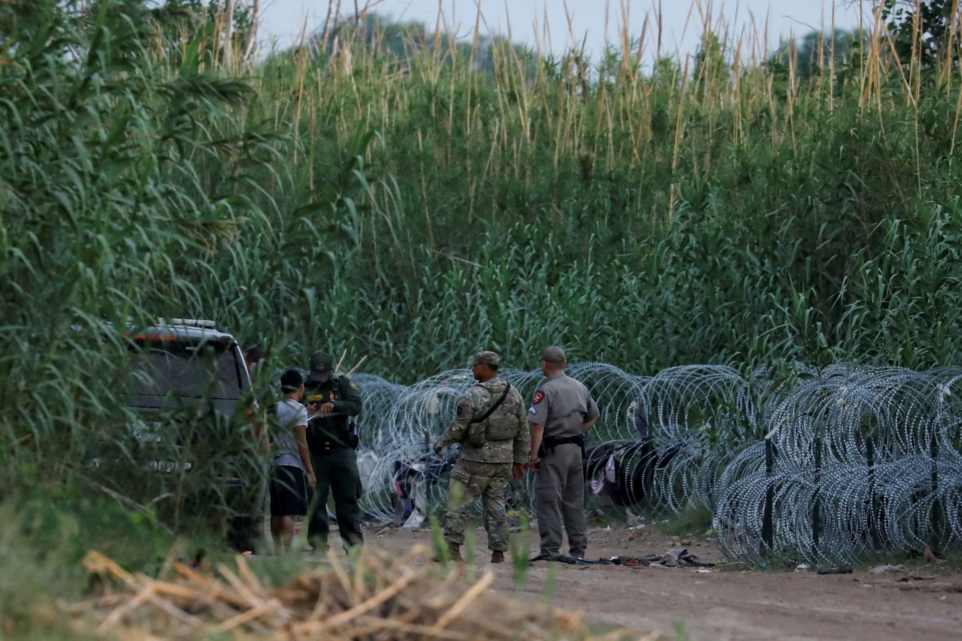 <p>A man talks with a Border Patrol agent after crossing the Rio Grande in Eagle Pass, Texas. </p>
