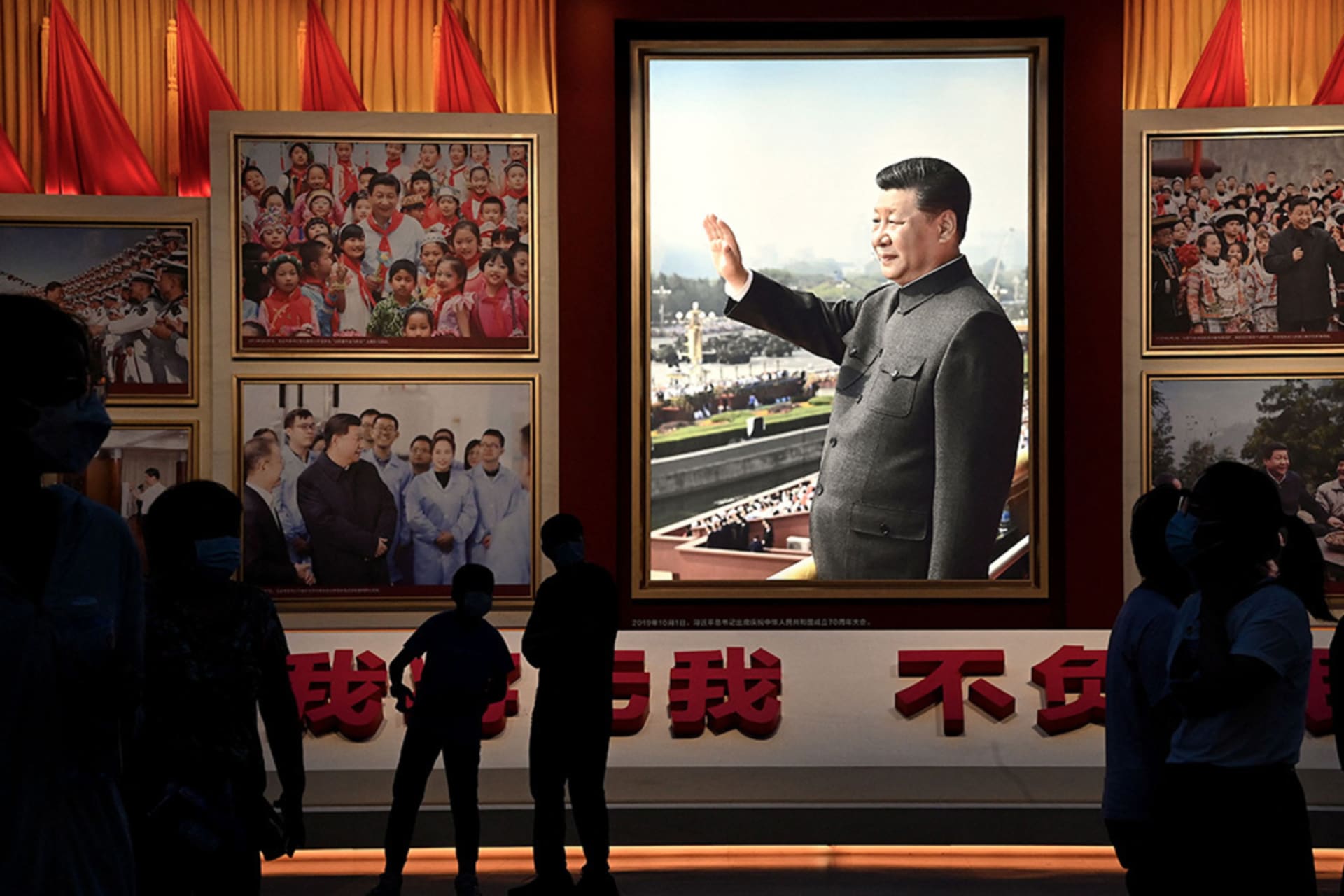 <p>People stand in front of images of Chinese leader Xi Jinping at the Museum of the Chinese Communist Party in Beijing.</p>
