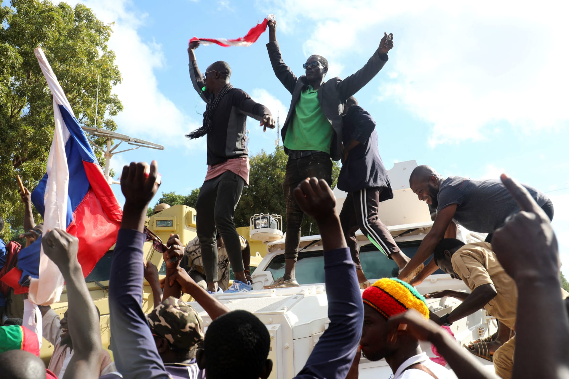 <p>Supporters of Burkina Faso’s self-declared new leader Ibrahim Traore demonstrate holding a Burkina Faso and Russian flags in Ouagadougou, Burkina Faso on October 2, 2022.</p>
