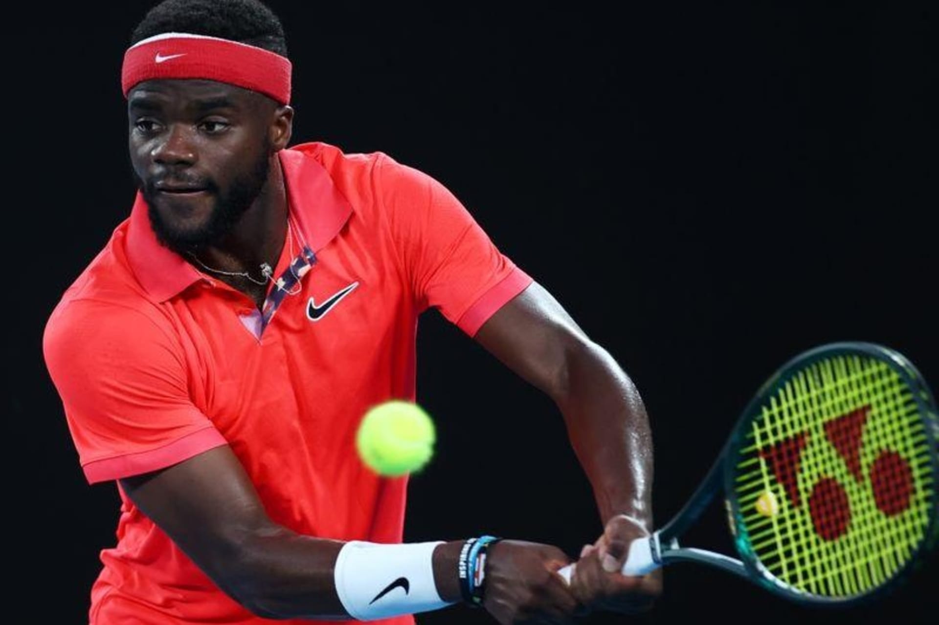 <p>Frances Tiafoe hits a volley during a match at the Australian Open in January 2020.</p>
