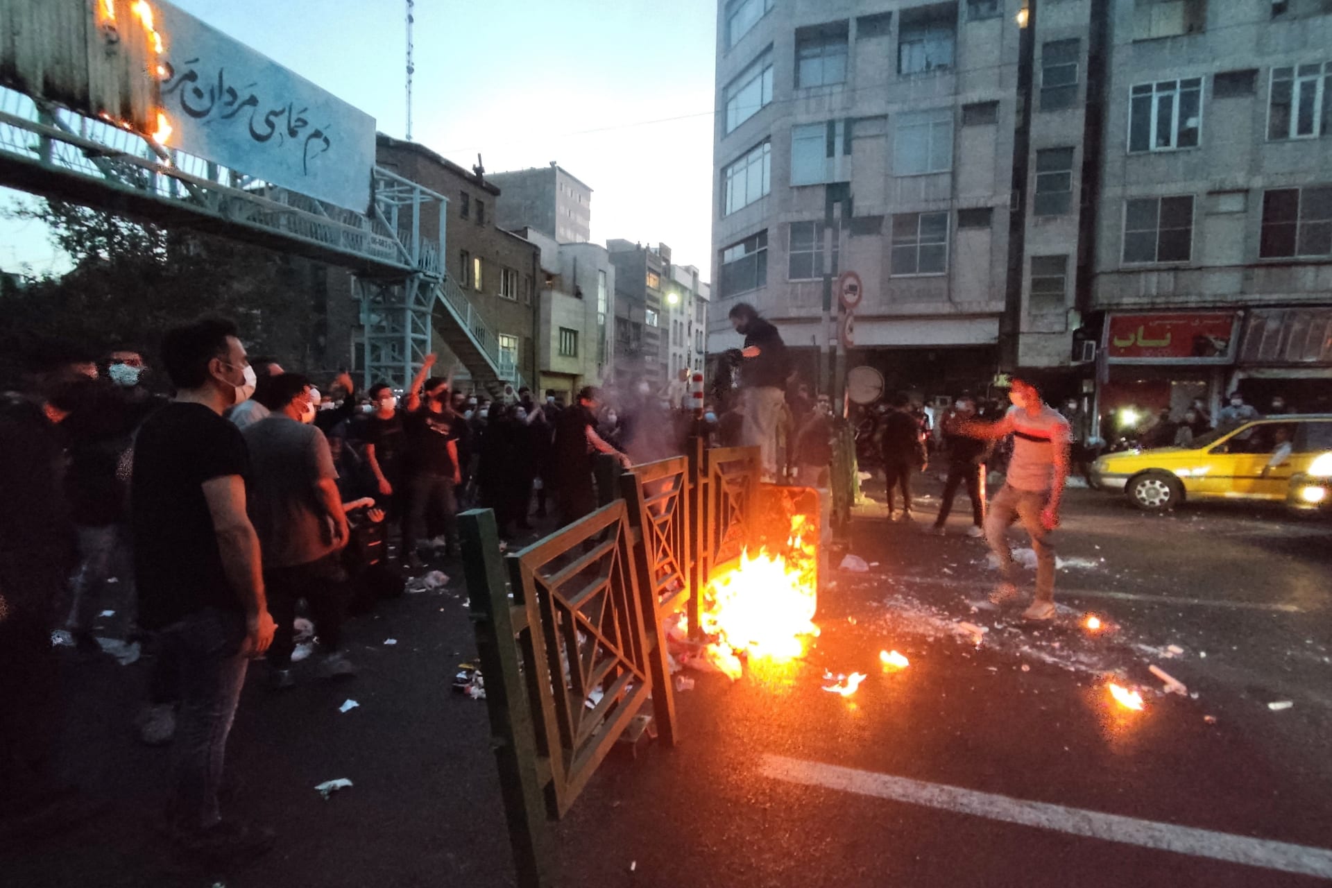 <p>Protestors in Iran light a fire during a demonstration following the death of Mahsa Amini in the custody of Iran’s morality police.</p>
