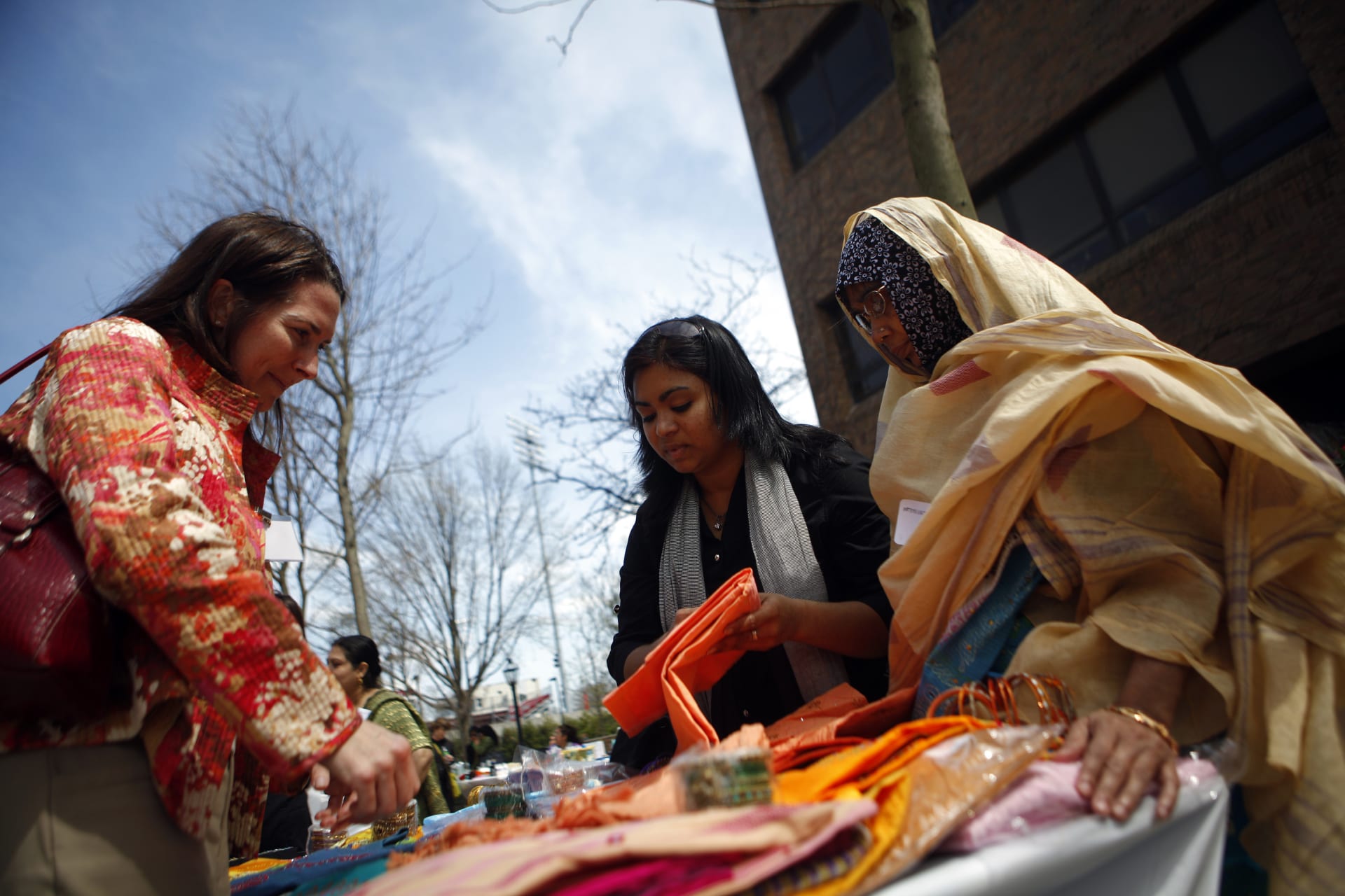 <p>Women sell items at a Grameen America open house at St. John’s University in New York</p>
