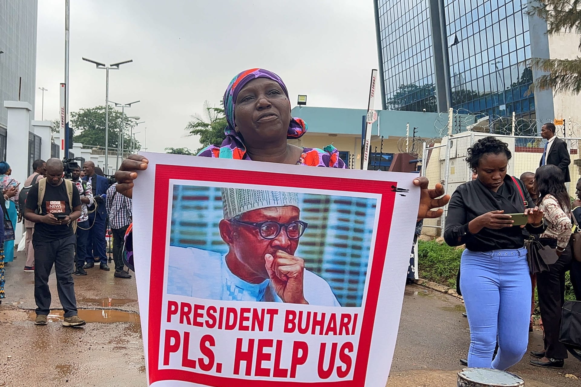 <p>A woman holds a poster of Nigeria’s president Muhammadu Buhari, as relatives of the Kaduna train kidnapped victims protest in Abuja, Nigeria on July 25, 2022.</p>
