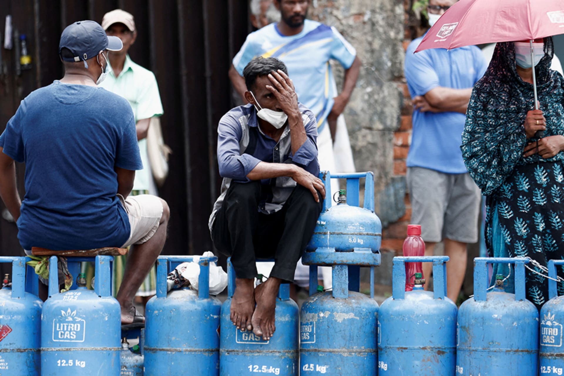 <p>People block a main road as they wait for gas trucks to arrive in Colombo, Sri Lanka.</p>
