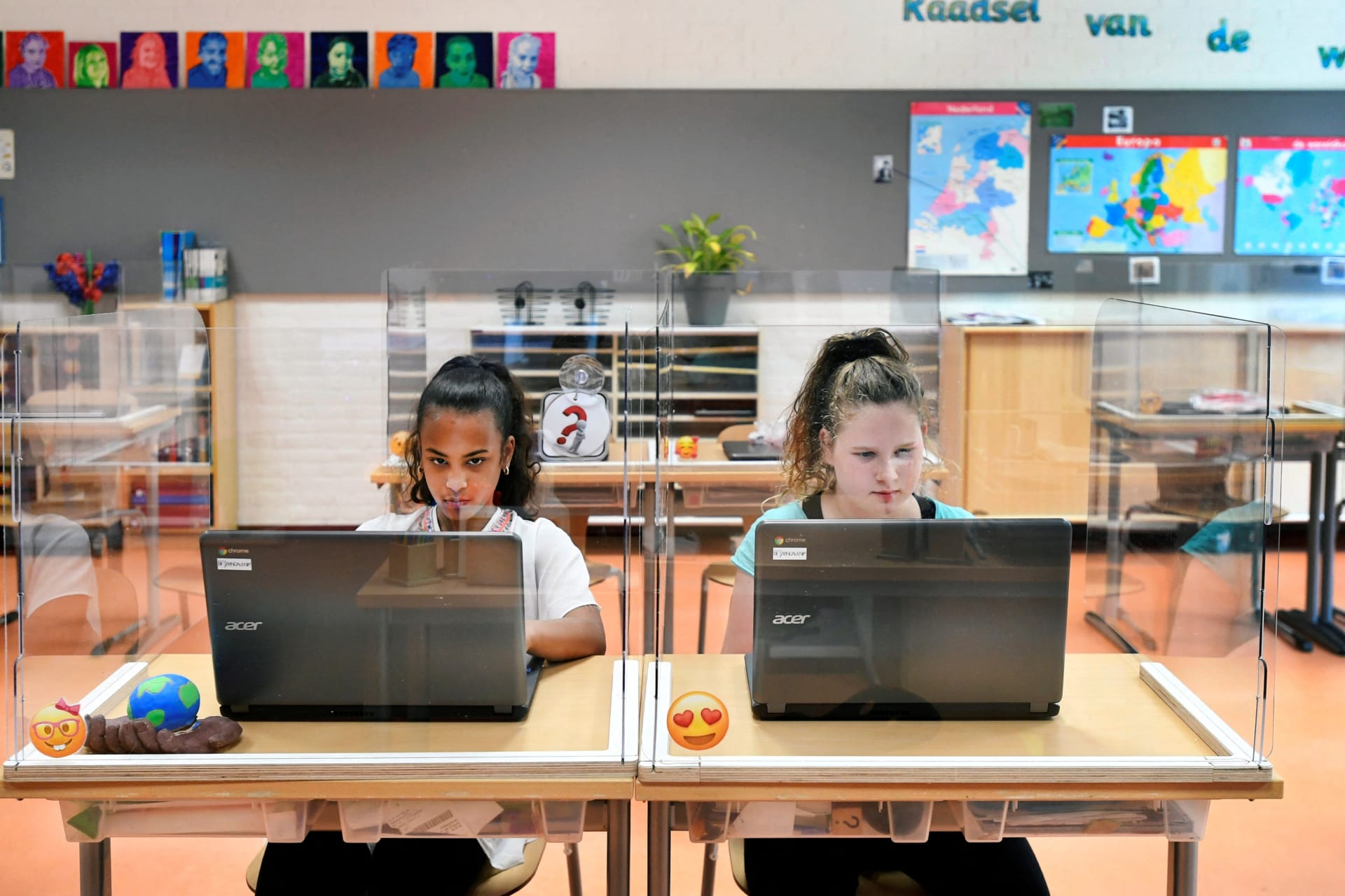 <p>Two Dutch students attend class at a primary school during a COVID-19 outbreak in the Netherlands in May 2020.</p>
