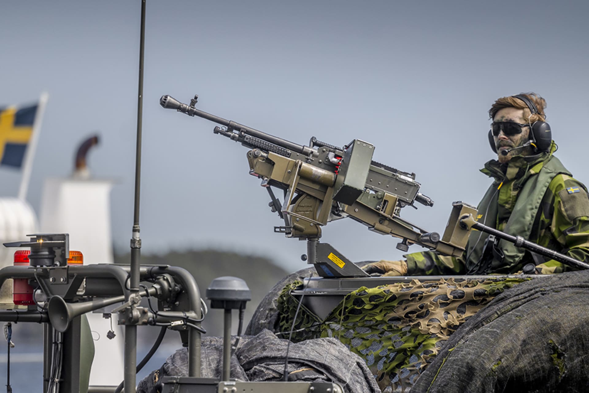 <p>A Swedish soldier sits on a military boat with a machine gun during NATO military drills in the Baltic Sea.</p>
