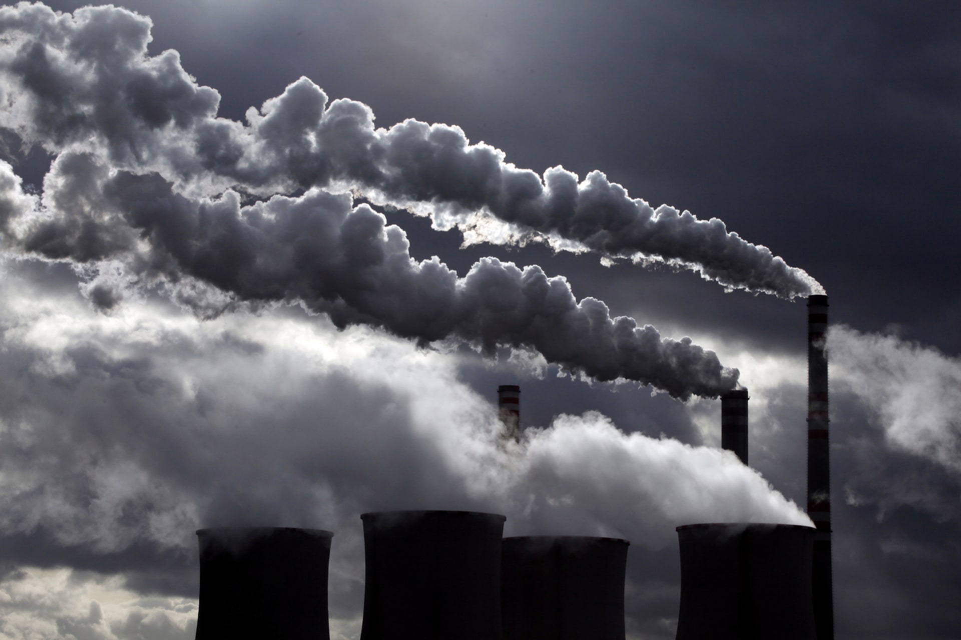 <p>Cooling towers and smoke stacks at a power plant. </p>
