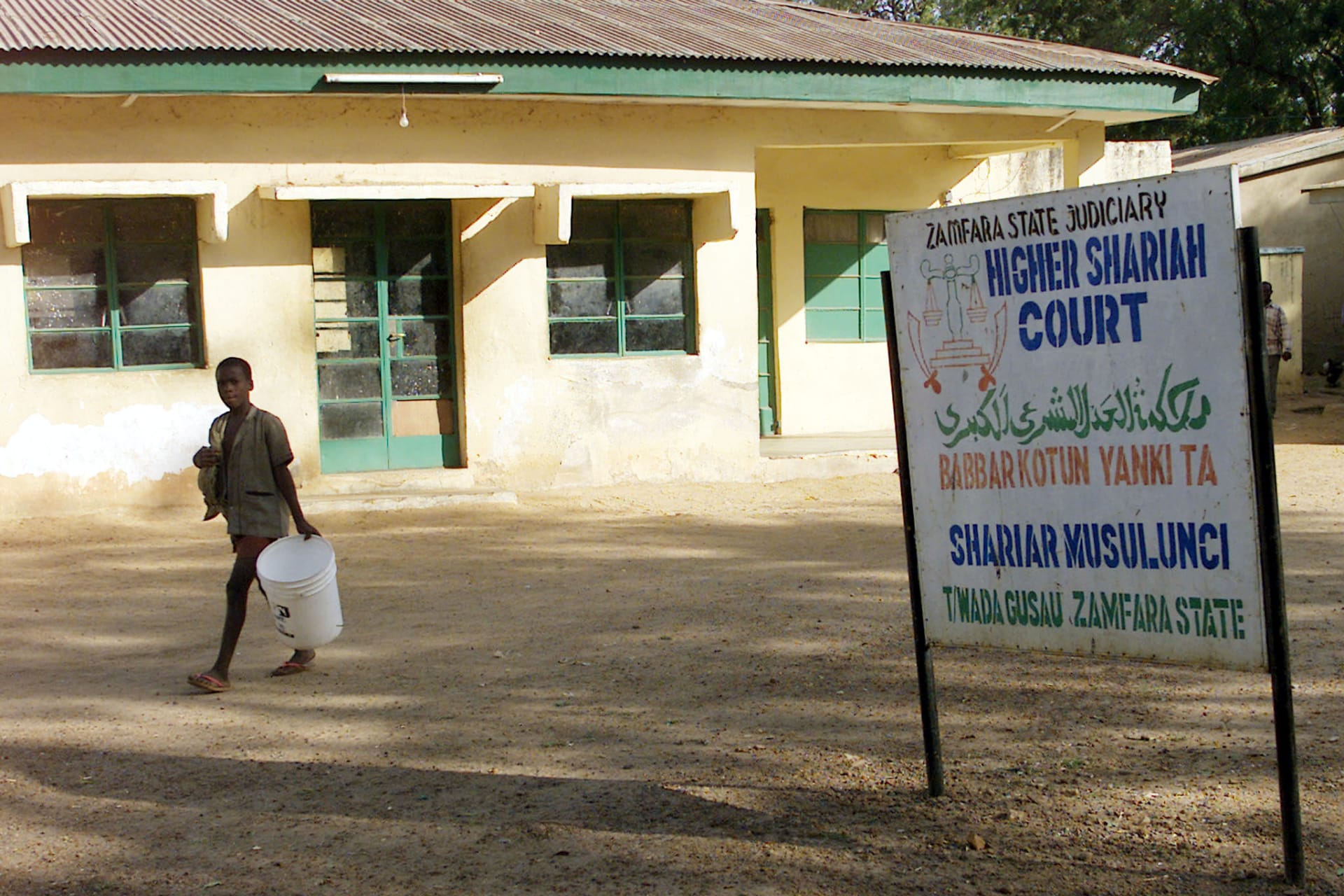 <p>A sign outside the Higher Shariah Court in Gusauthe in the state of Zamfara, Nigeria, in November, 2002</p>
