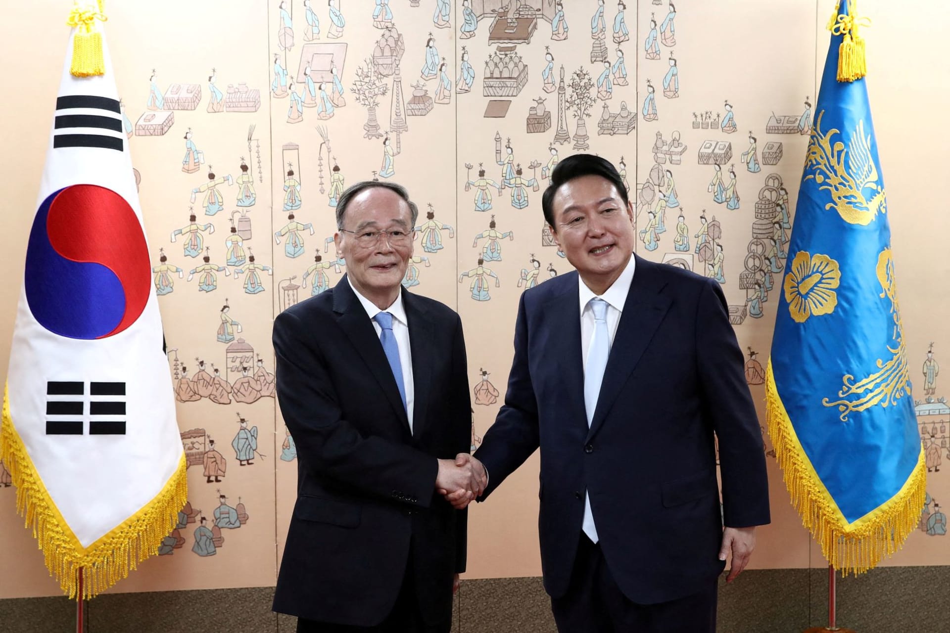 <p>South Korean President Yoon Suk-yeol shakes hands with Chinese Vice President Wang Qishan after his inauguration ceremony at new presidential office in Seoul, South Korea on May 10, 2022.</p>
