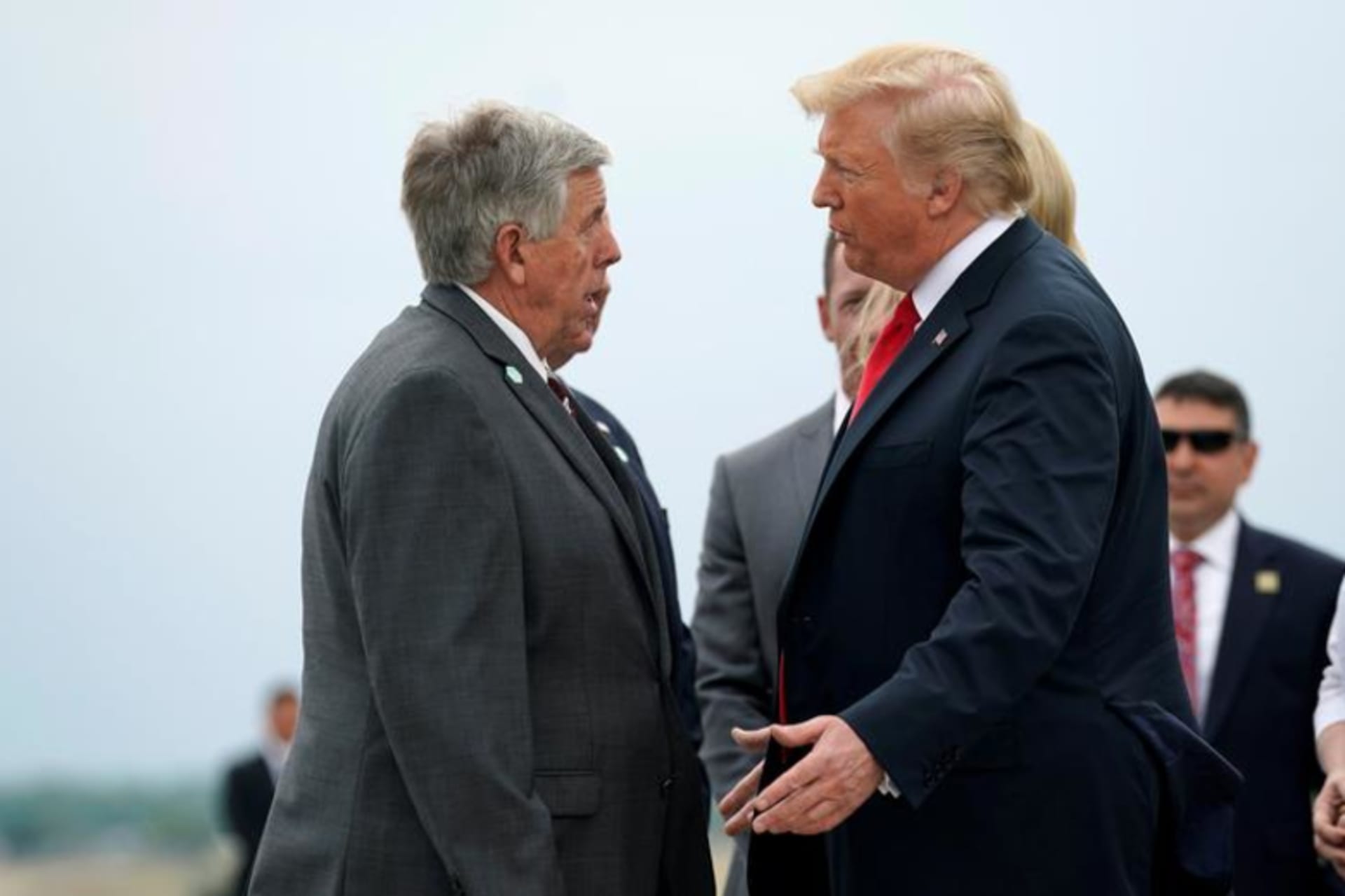 <p>Missouri Governor Mike Parson and President Donald Trump speak at the airport in St. Louis, Missouri in July 2018.</p>

