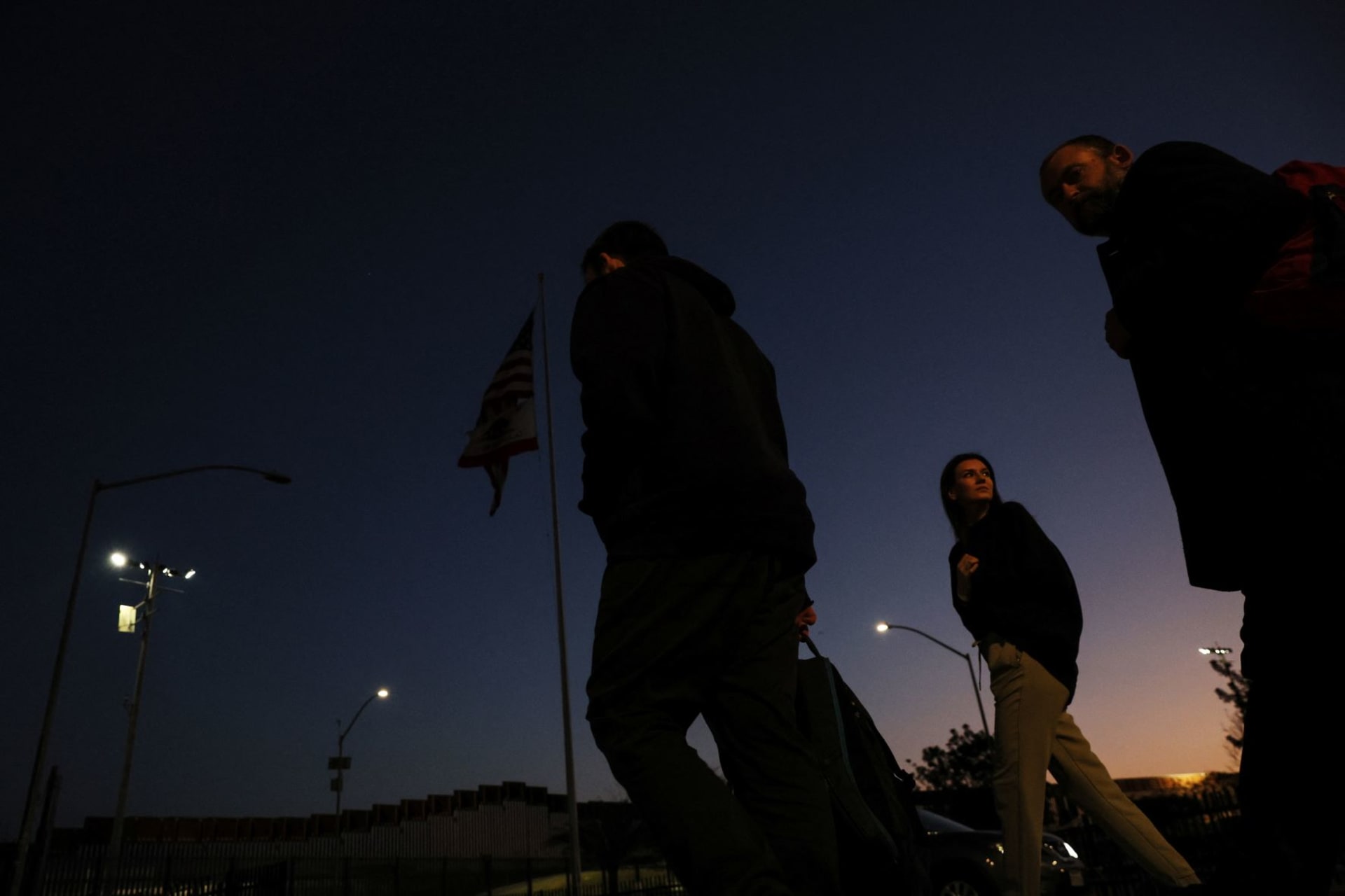 <p>Ukrainian people seeking asylum in the United States amid Russia’s invasion of Ukraine, walk after arriving at the PedWest border crossing to a volunteer welcome center at the San Ysidro Port of Entry in San Diego, California on April 12, 2022.</p>

