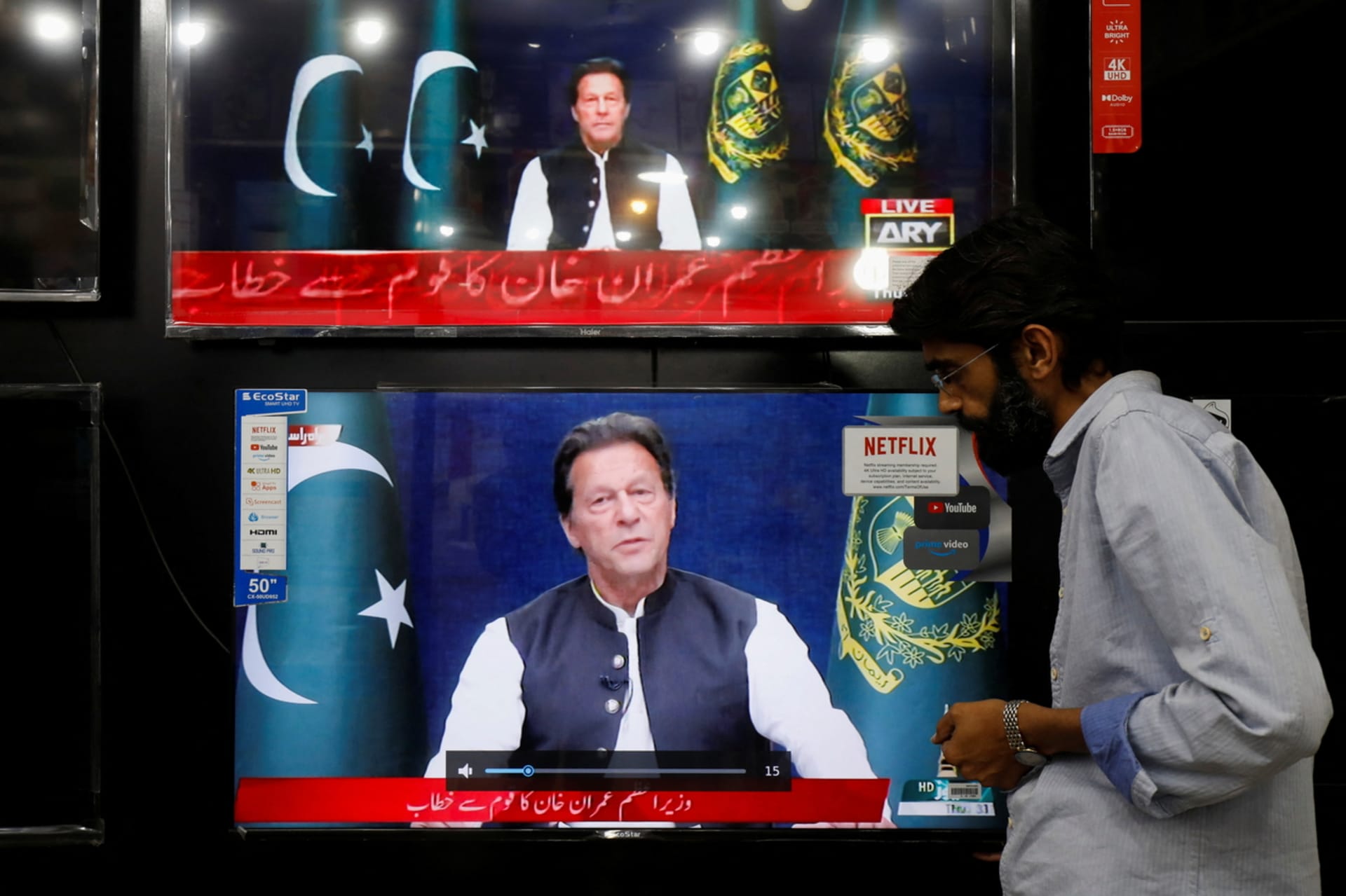 <p>A shopkeeper tunes a television screen to watch the speech of Pakistani Prime Minister Imran Khan, at his shop in Islamabad, Pakistan, March 31, 2022.</p>
