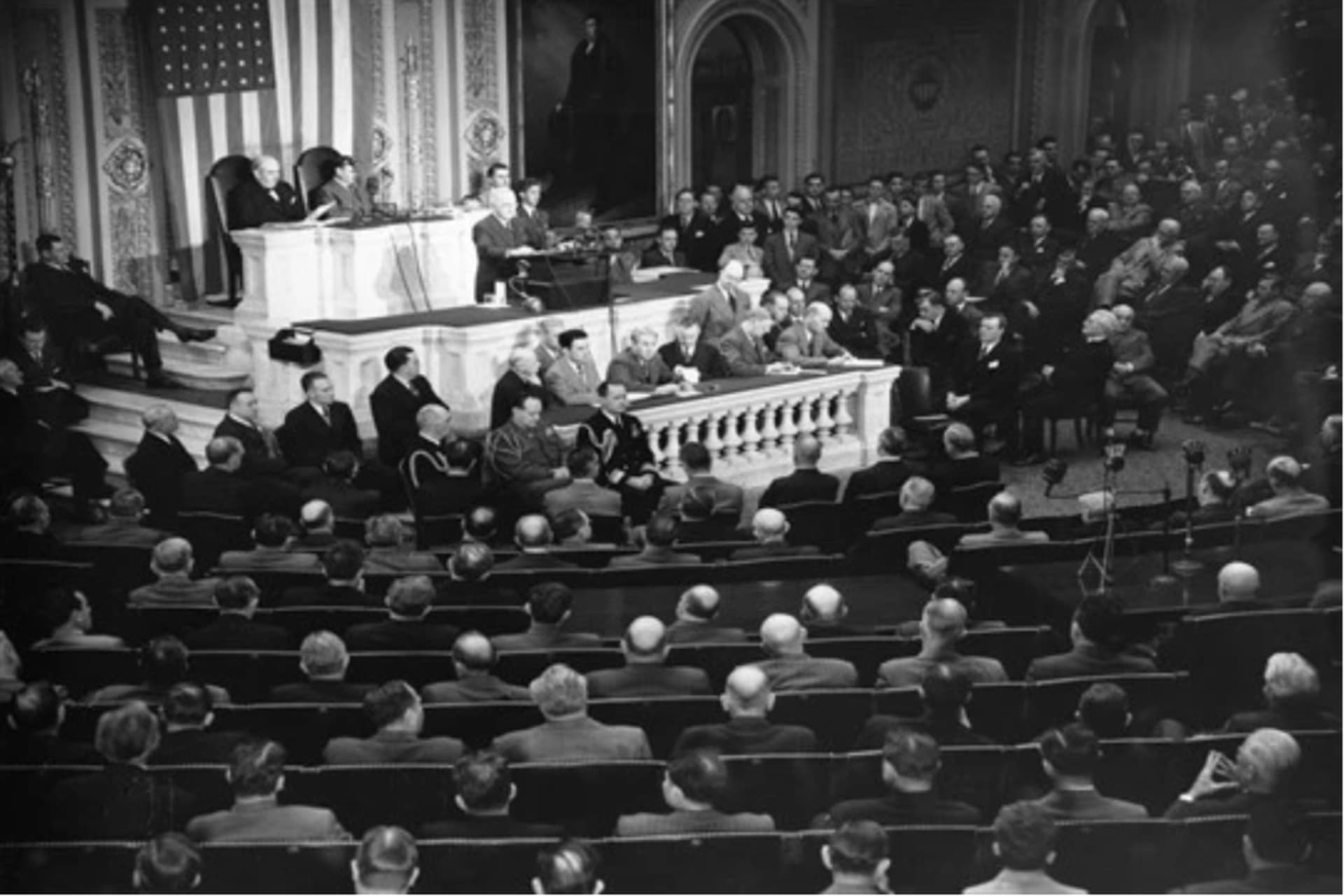 <p>U.S. President Harry S. Truman, standing at podium, addresses a joint session of Congress in the House Chamber in Washington, D.C., March 12, 1947.</p>
