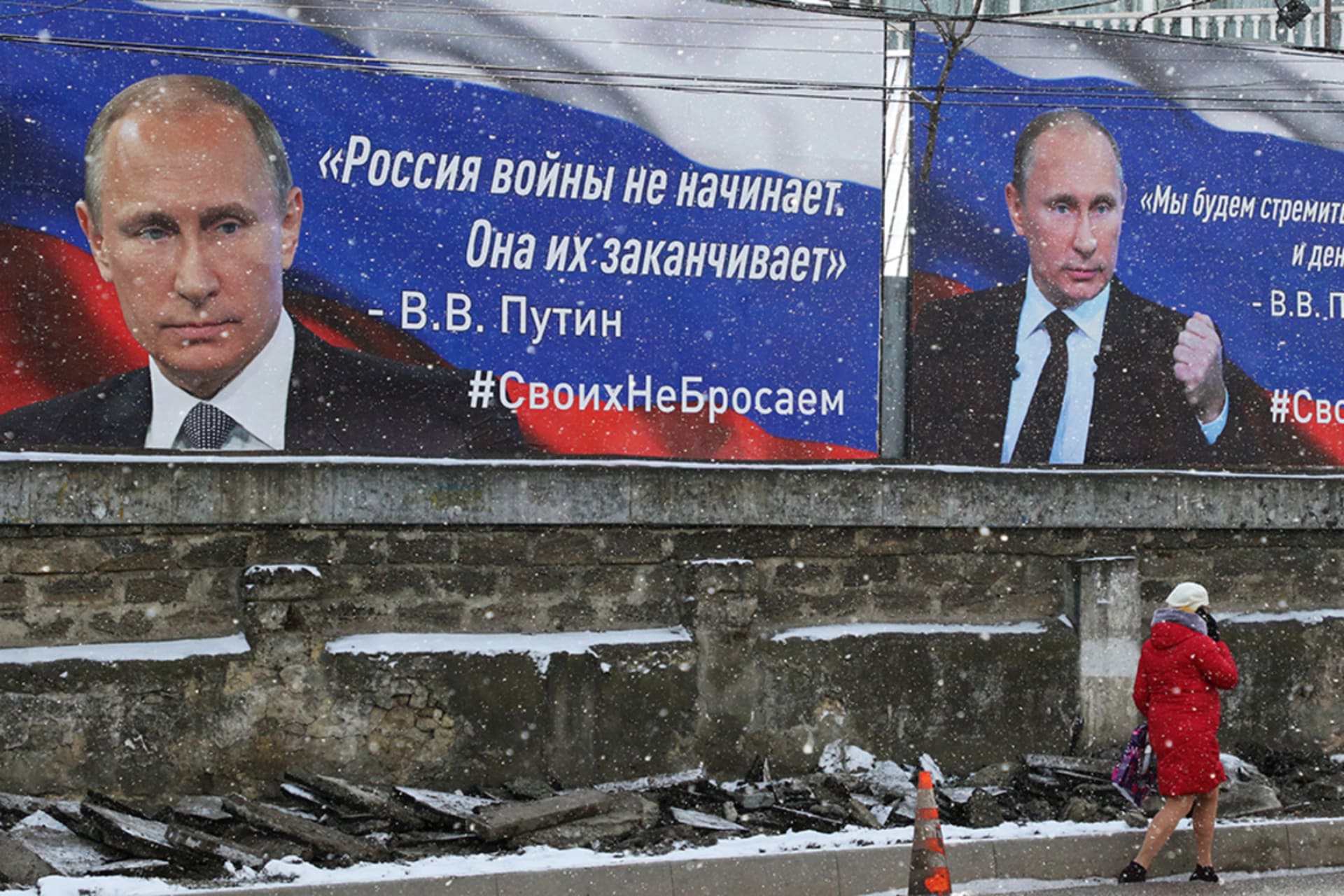 <p>A woman walks past boards with portraits of Russian President Vladimir Putin in Simferopol, Crimea March 11, 2022. </p>
