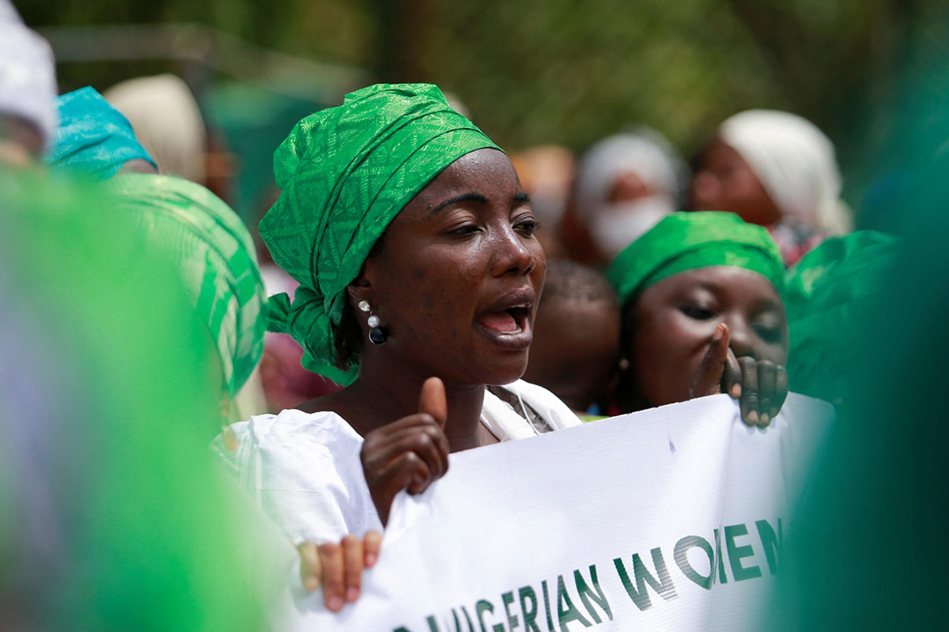 <p>A woman holds a banner during a protest against legislative bias against women in Abuja, Nigeria, on International Women’s Day.</p>
