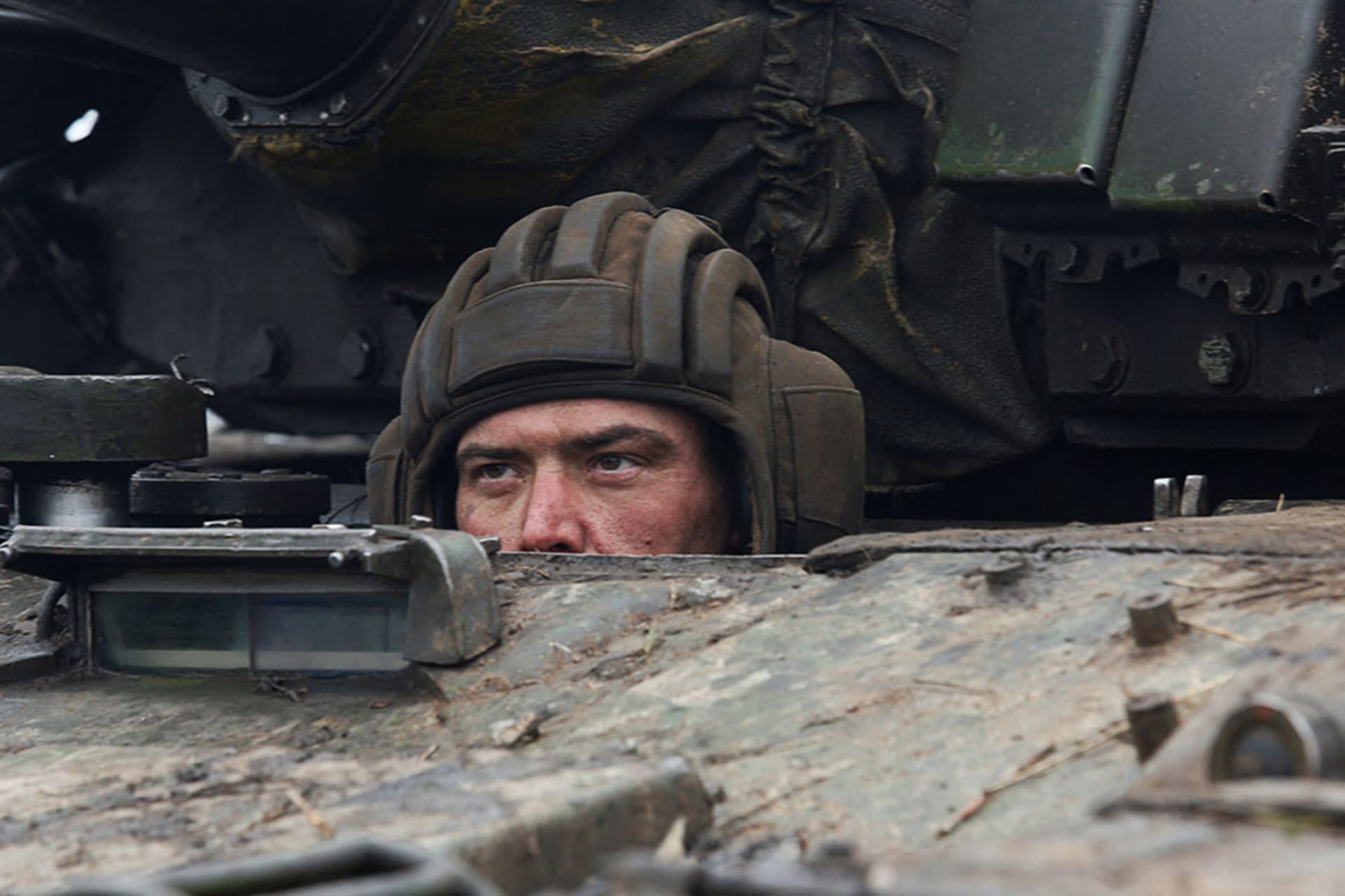 <p>A serviceman of pro-Russian militia in a tank of armed forces of the separatist self-proclaimed Luhansk People’s Republic on February 27, 2022</p>