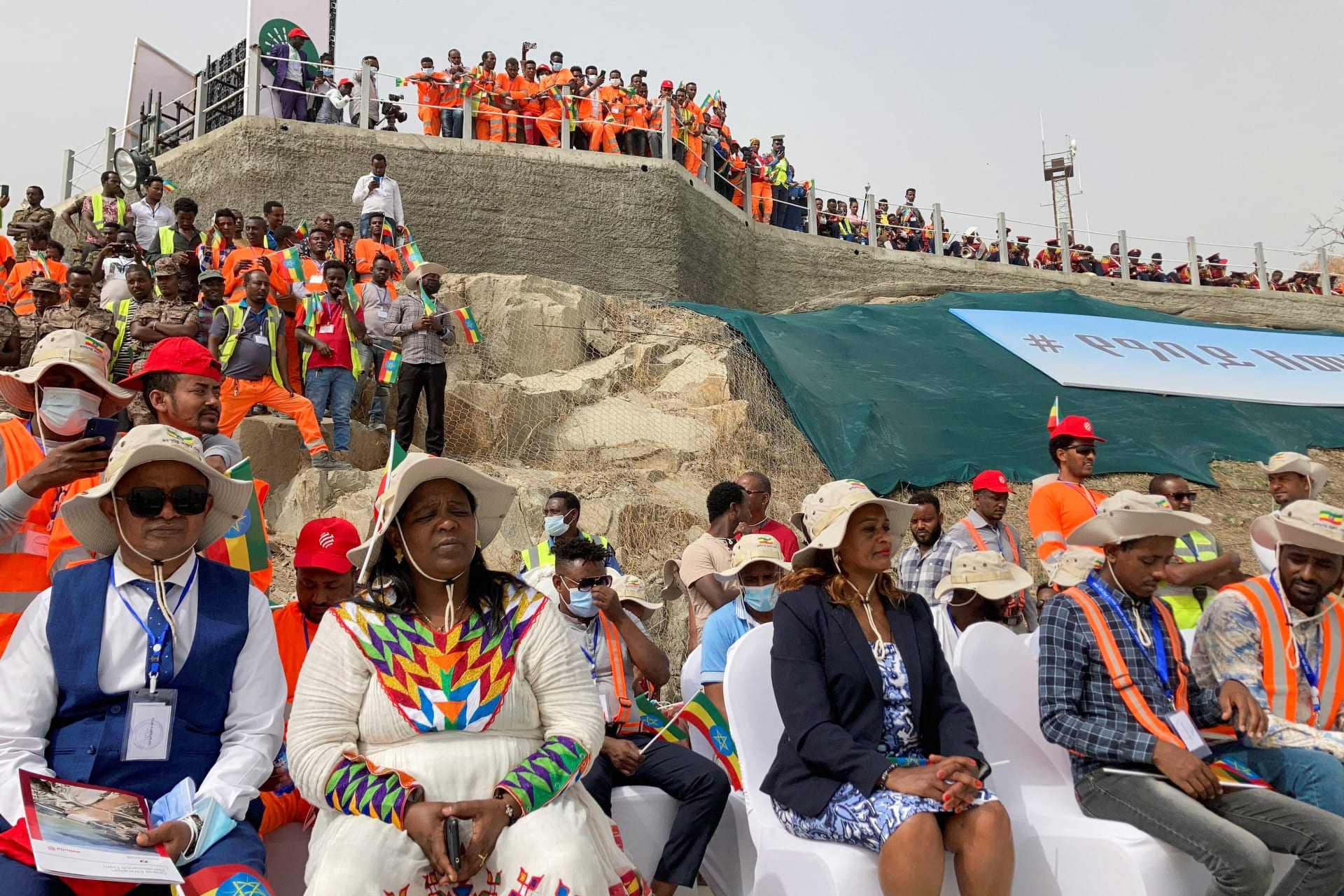 <p>Delegates attend the ceremony at the Grand Ethiopian Renaissance Dam (GERD) as it began producing electricity from its mega-dam on the Blue Nile in Guba Woreda, Benishangul Gumuz Region, Ethiopia on February 20, 2022.</p>
