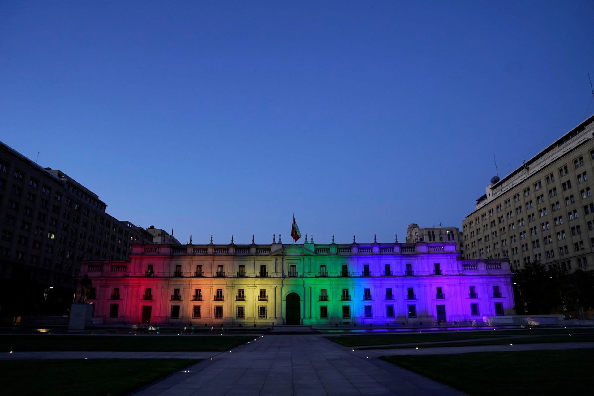 <p>Chile’s government palace is illuminated with the LGBT flag colours after the Senate approved a same-sex marriage bill in Santiago, Chile, December 7, 2021. </p>

