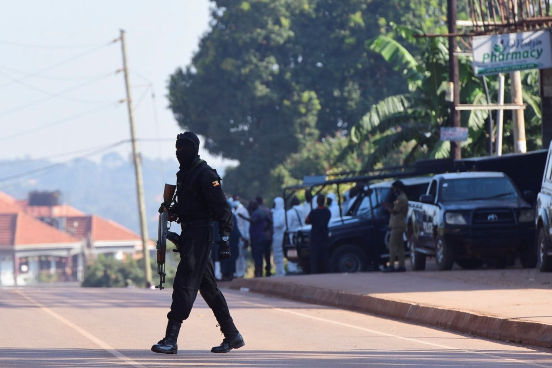 <p>Ugandan police members secure the scene of an explosion in Komamboga, a suburb on the northern outskirts of Kampala, Uganda on October 24, 2021.</p>
