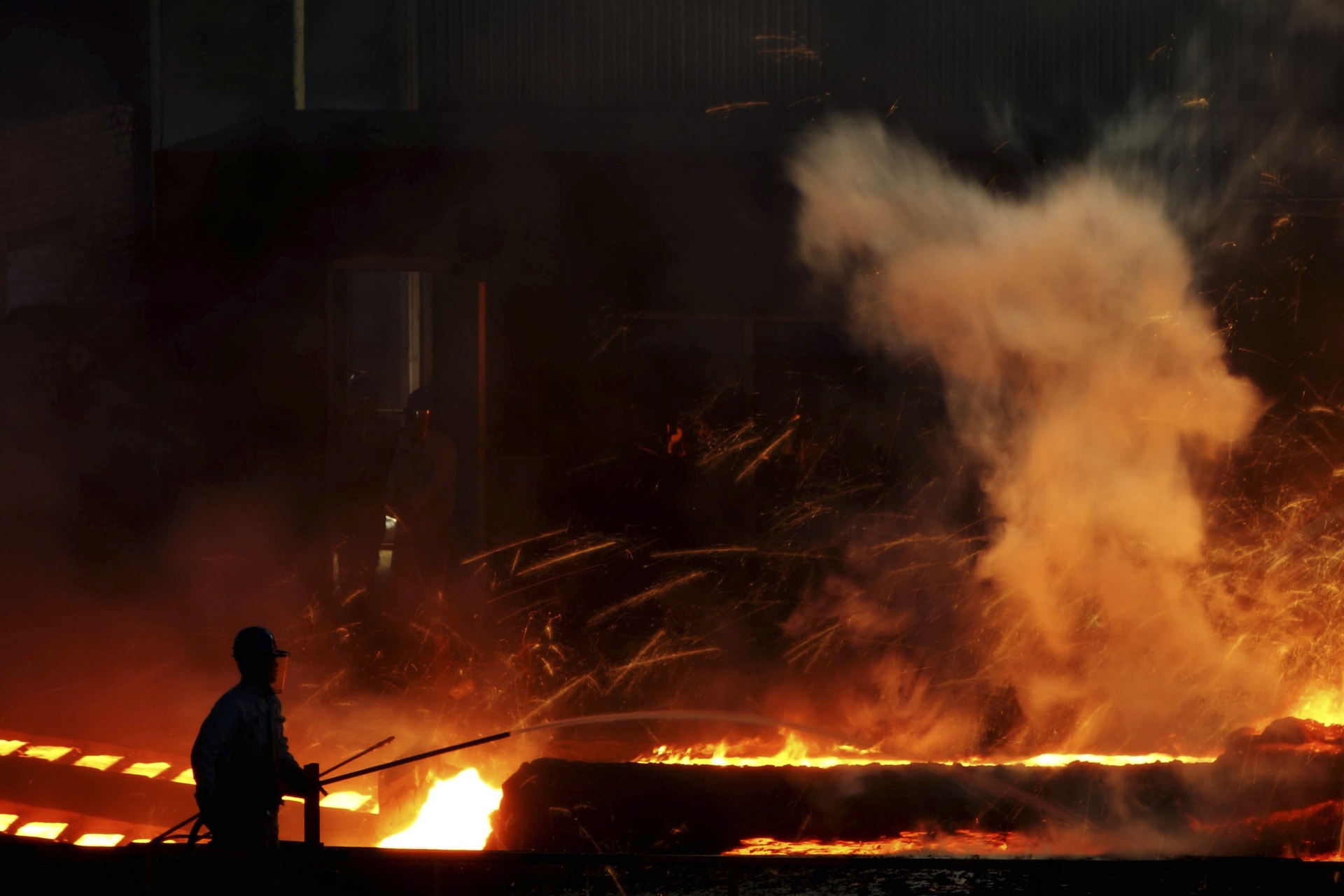 <p>A laborer works inside a steel factory in Dalian, China on October 11, 2013</p>
