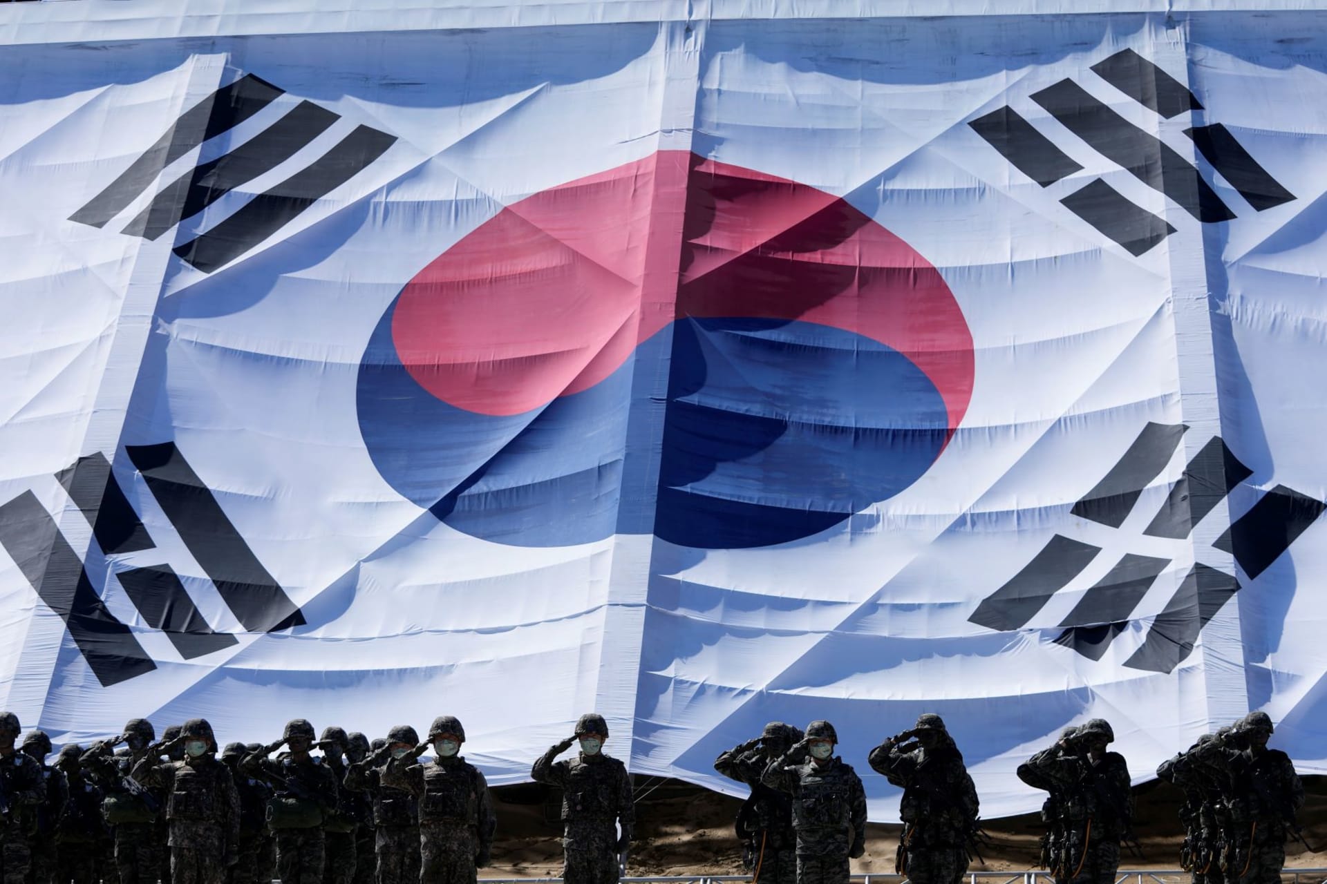 <p>South Korean soldiers salute their country’s flag in celebration of Armed Forces Day.</p>