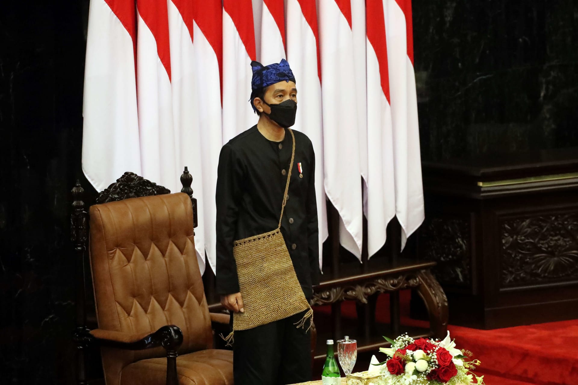 <p>Indonesian President Joko Widodo stands before delivering his State of the Nation Address ahead of the country’s Independence Day, at the parliament building in Jakarta, Indonesia, on August 16, 2021.</p>
