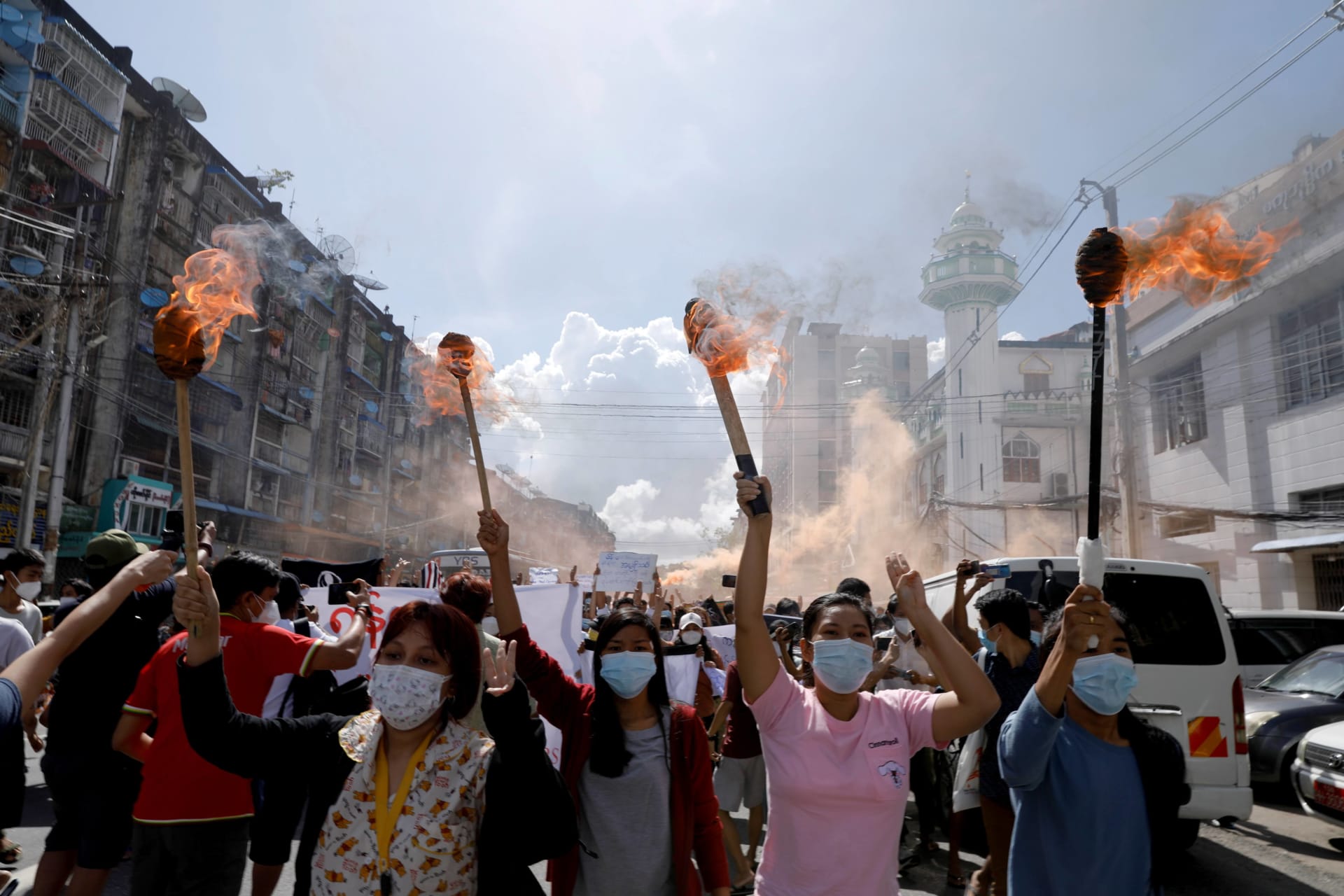 <p>A group of women hold torches as they protest against the military coup in Yangon, Myanmar, on July 14, 2021.</p>
