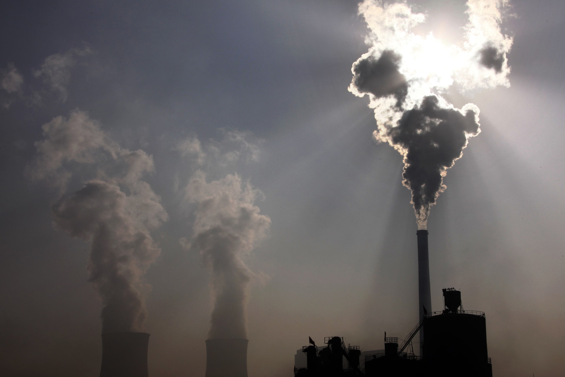 <p>A coal-burning power plant can be seen behind a factory in the city of Baotou, in China’s Inner Mongolia Autonomous Region October 31, 2010.</p>

