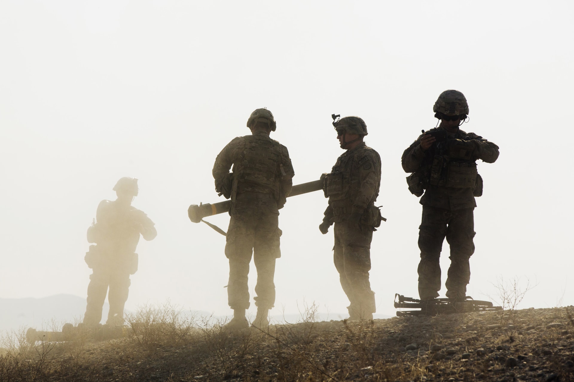 <p>U.S. soldiers from D Troop of the 3rd Cavalry Regiment walk on a hill after finishing with a training exercise near forward operating base Gamberi in the Laghman province of Afghanistan December 30, 2014.</p>

