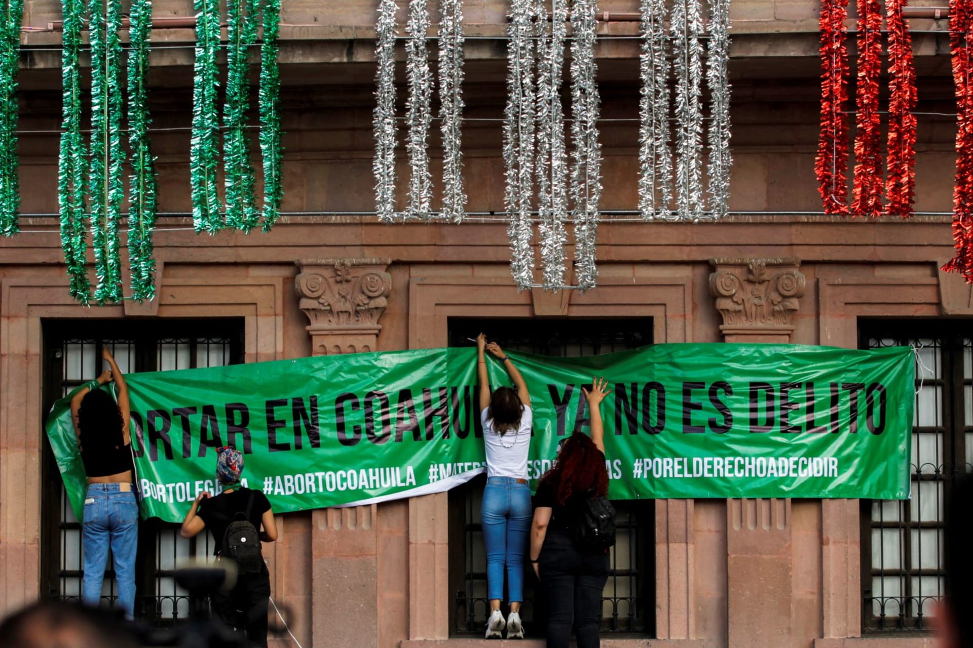 <p>Women hang up a banner that says “Abortion in Coahuila is no longer a crime” following the Mexican Supreme Court ruling that decriminalized abortion.</p>
