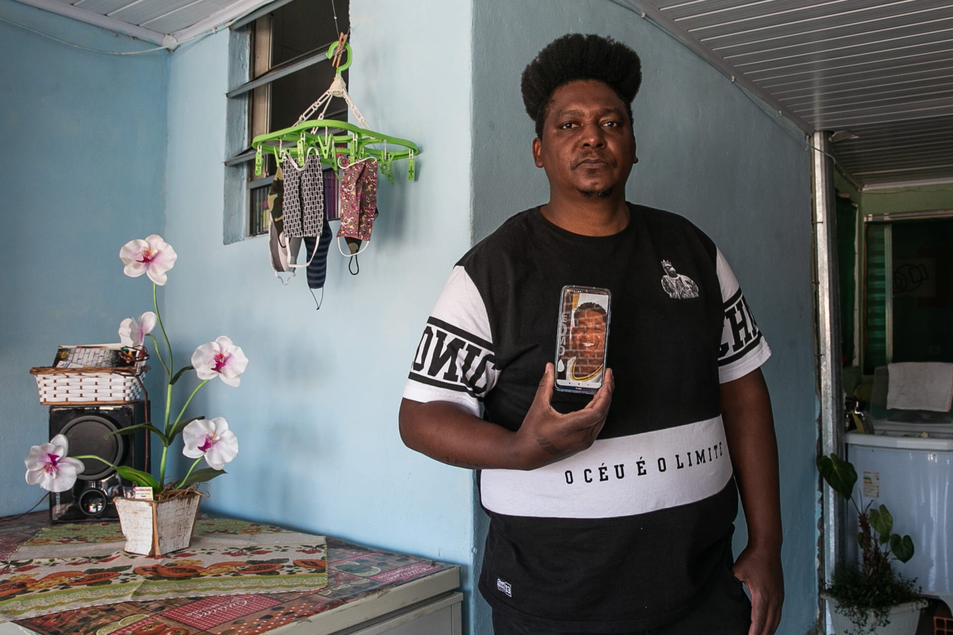 <p>Marcelo Louzada holds a photo of his brother Valdemar Louzada, thirty-eight, in Sao Paulo, Brazil. Valdemar suffered from obesity and died from COVID-19 in May 2020.</p>
