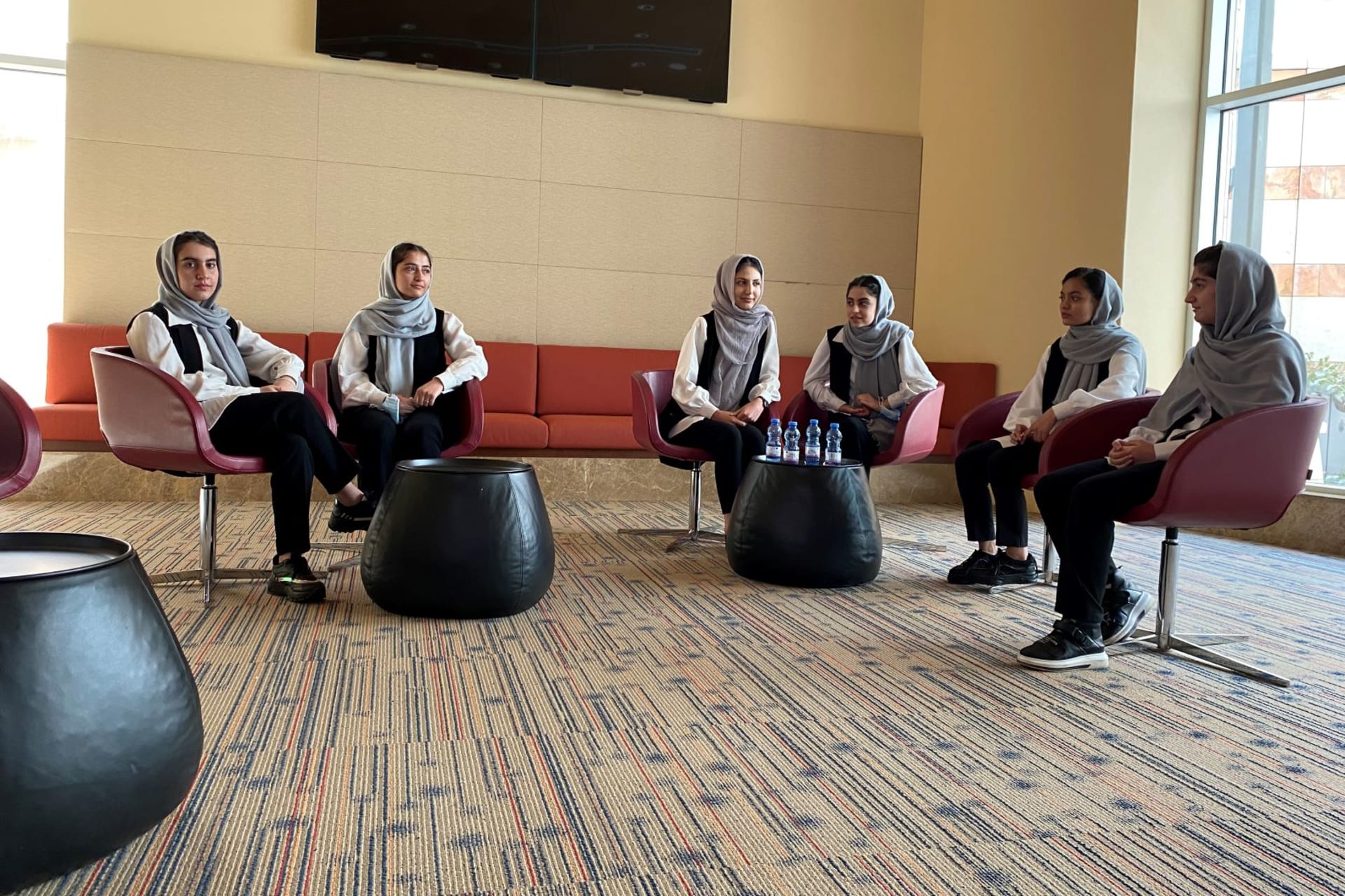 <p>Members from the Afghan girls robotics team chat during a Reuters interview in Doha, after being evacuated from Afghanistan. </p>

