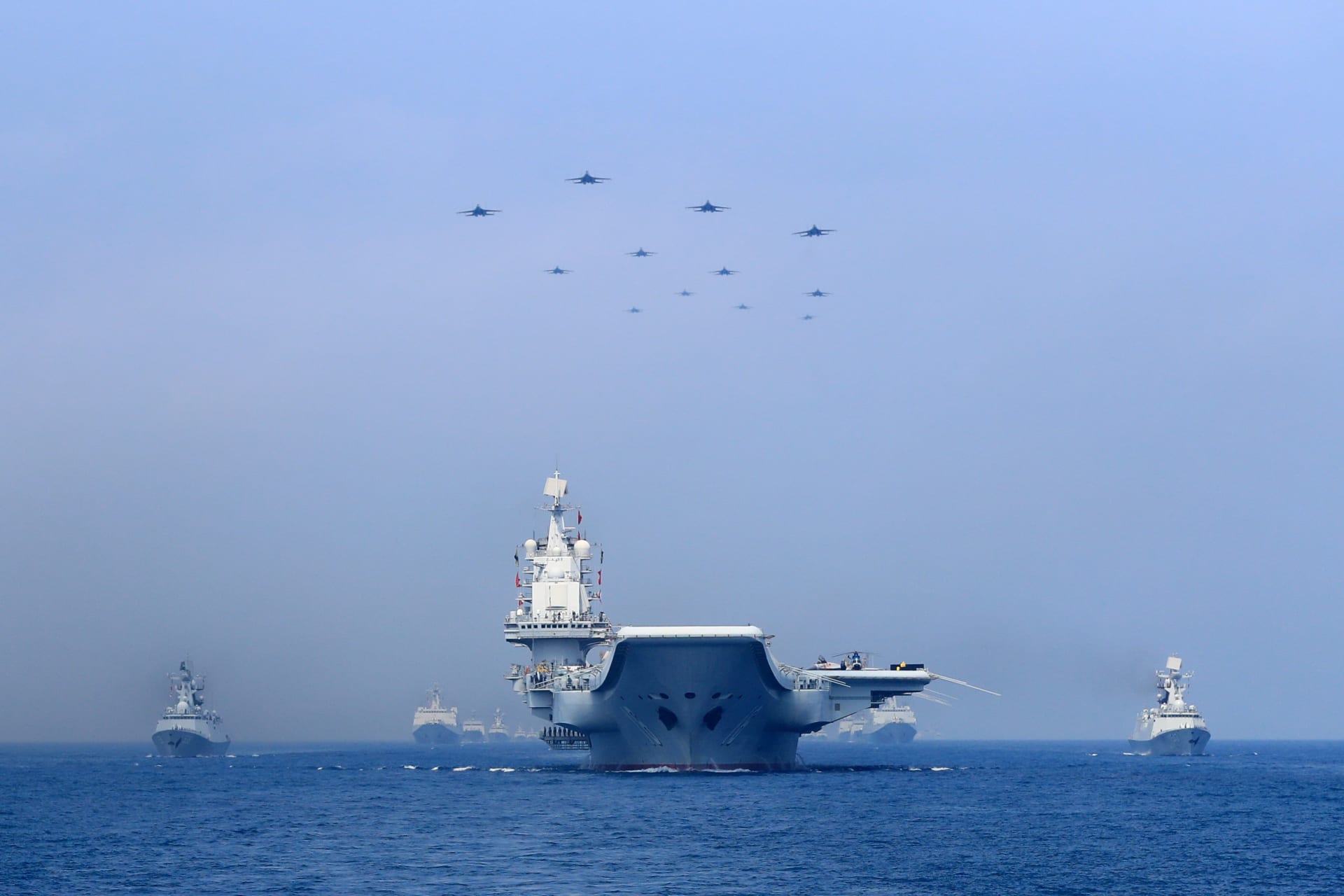 <p>Warships and fighter jets of Chinese People’s Liberation Army (PLA) Navy take part in a military display in the South China Sea on April 12, 2018.</p>