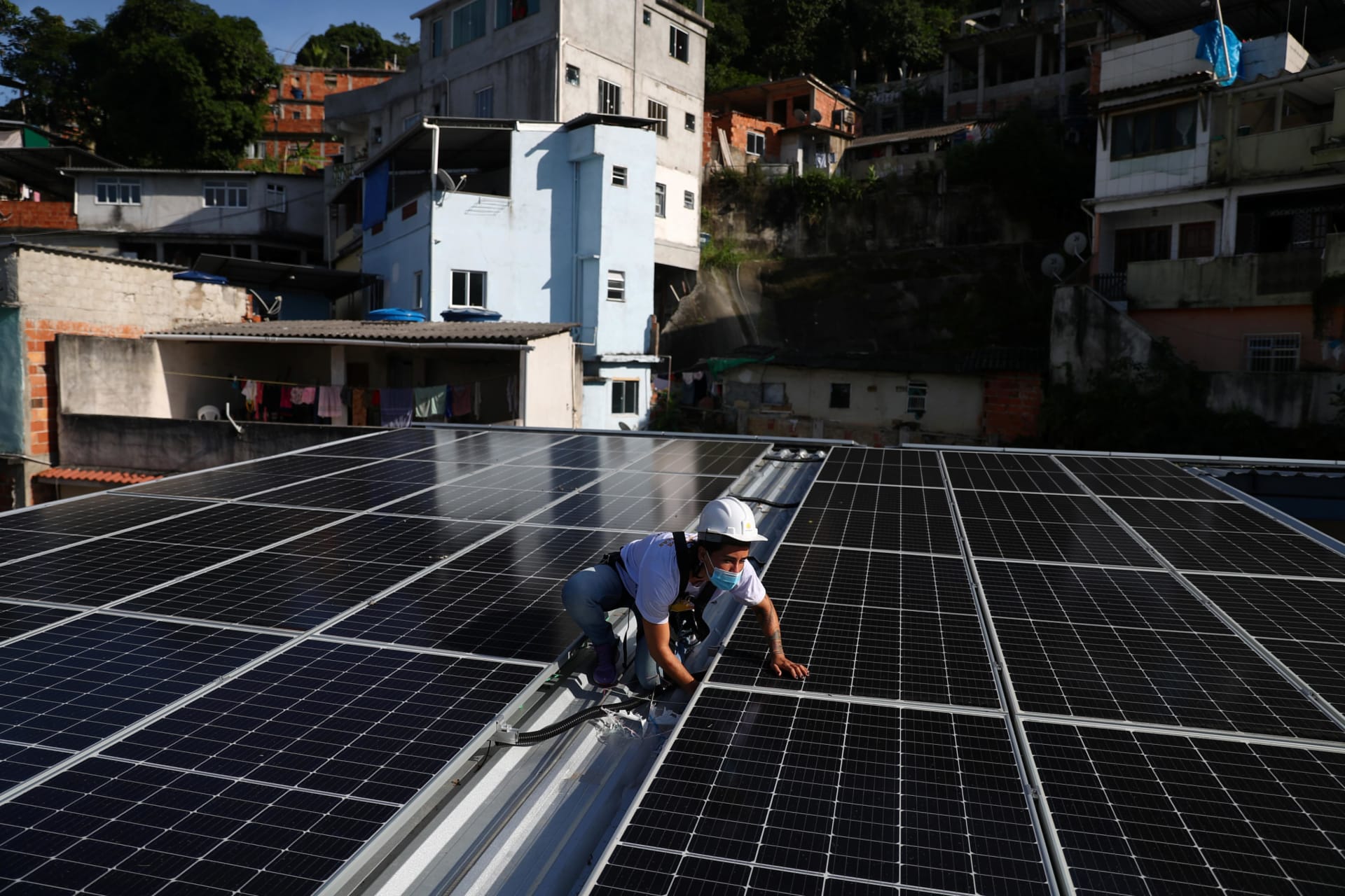 <p>A worker installs solar panels in Rio de Janeiro</p>
