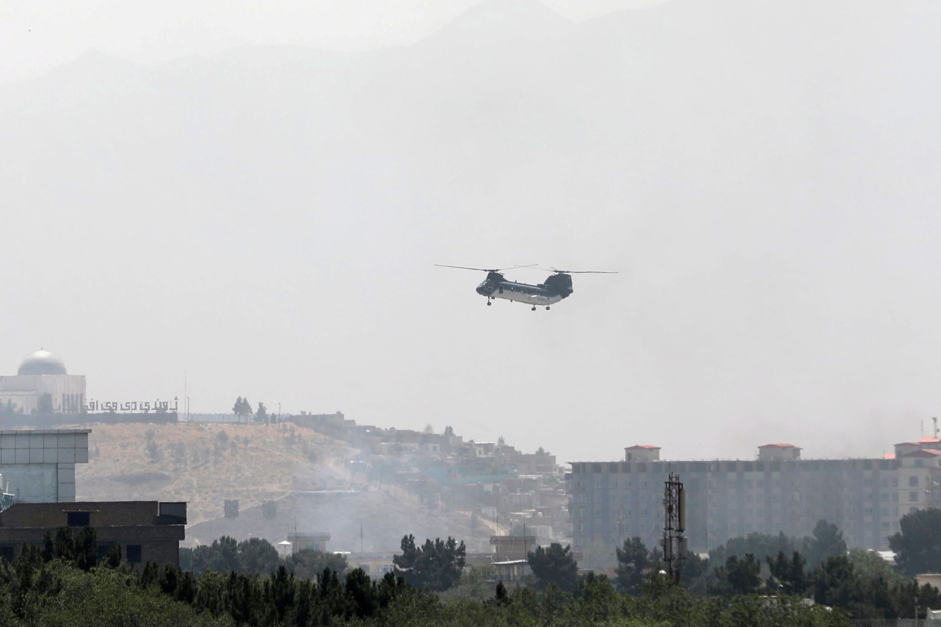 <p>A CH-46 Sea Knight military transport helicopter flies over Kabul, Afghanistan.</p>
