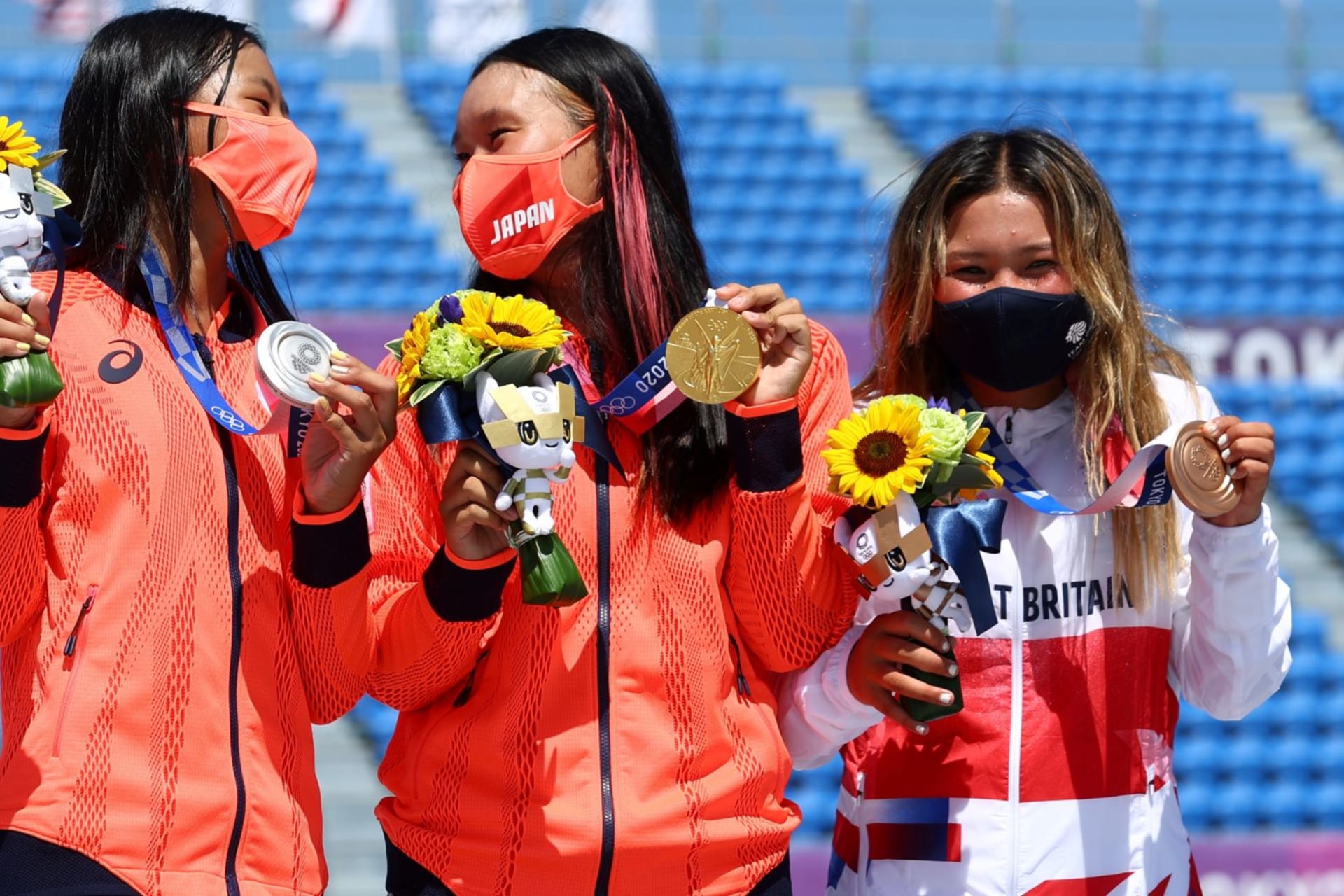<p>Sakura Yosozumi, Cocona Hiraki, and Sky Brown celebrate their respective gold, silver, and bronze medals for skateboarding at the 2021 Tokyo Olympic Games.</p>
