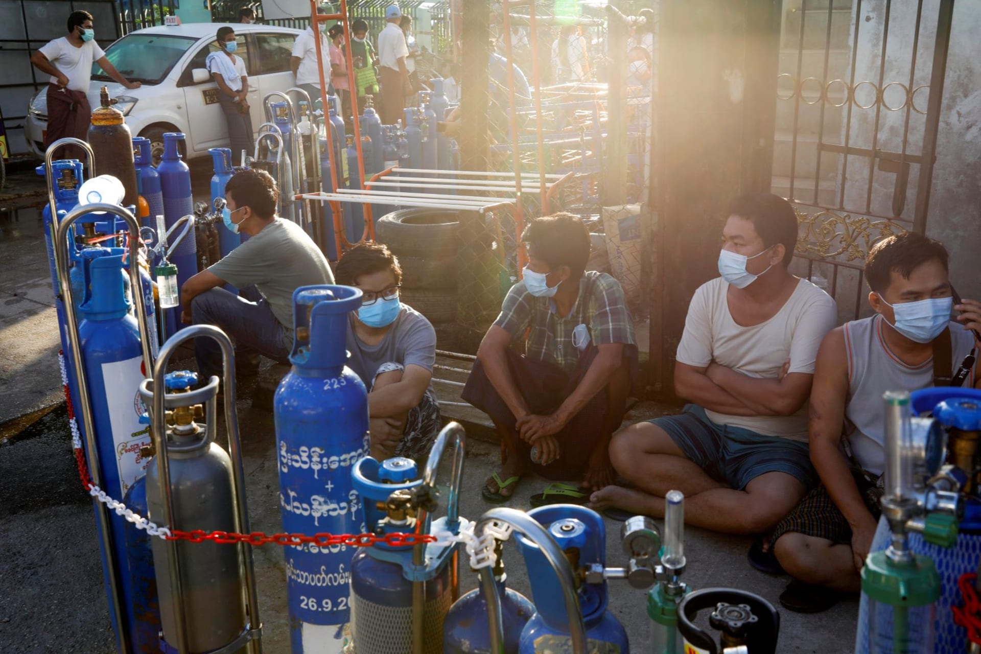 <p>Locals line up with their tanks to refill oxygen during the coronavirus disease (COVID-19) outbreak in Yangon, Myanmar, July 14, 2021.</p>
