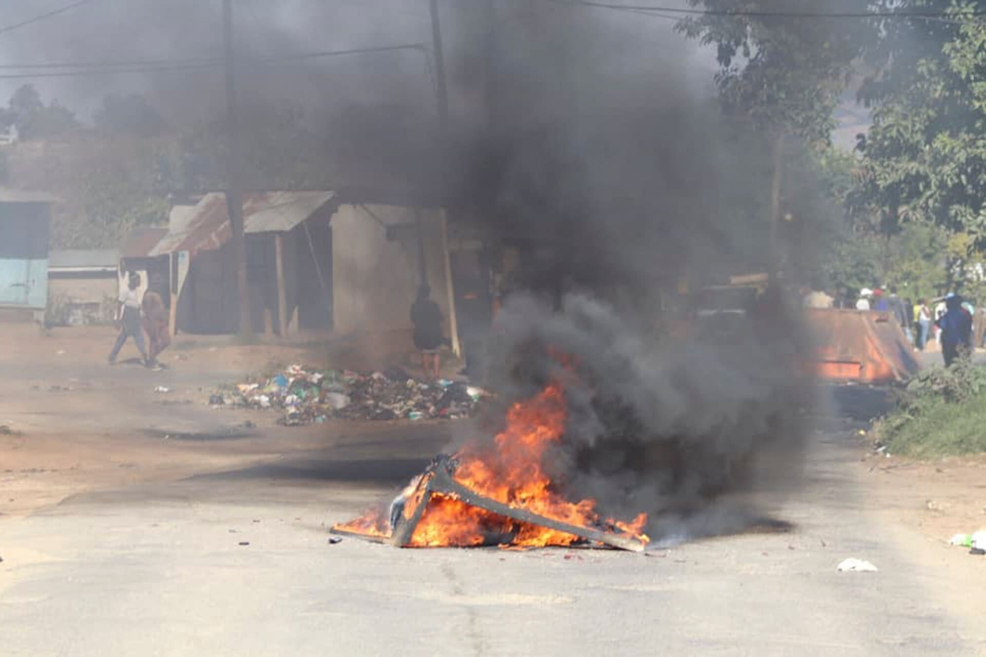 <p>A barricade is set ablaze in the road during a protest in Mbabane, eSwatini, June 29, 2021.</p>
