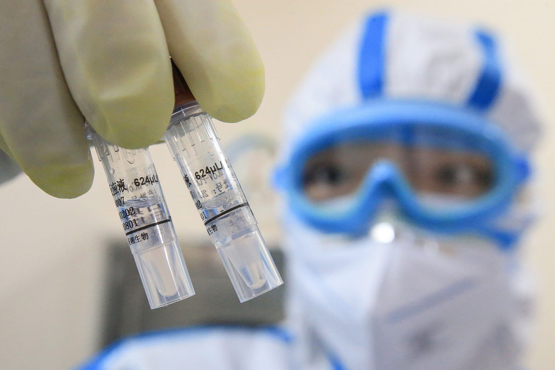 <p>A technician holds virus samples at a laboratory in Hengyang, China, in February 2020.</p>
